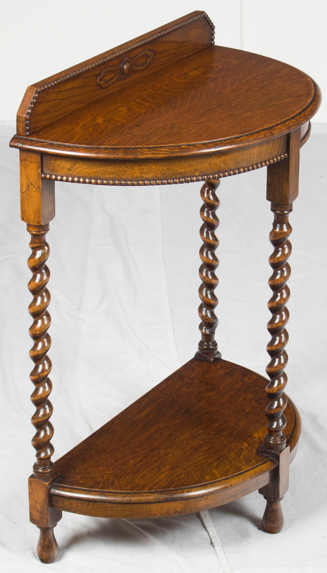 This piece was made in England, circa 1920 or so. It features beaded moldings and barley twist legs combined to form a gorgeous piece of furniture. If you are looking for a stunning antique half moon table, look not further!

The primary wood used