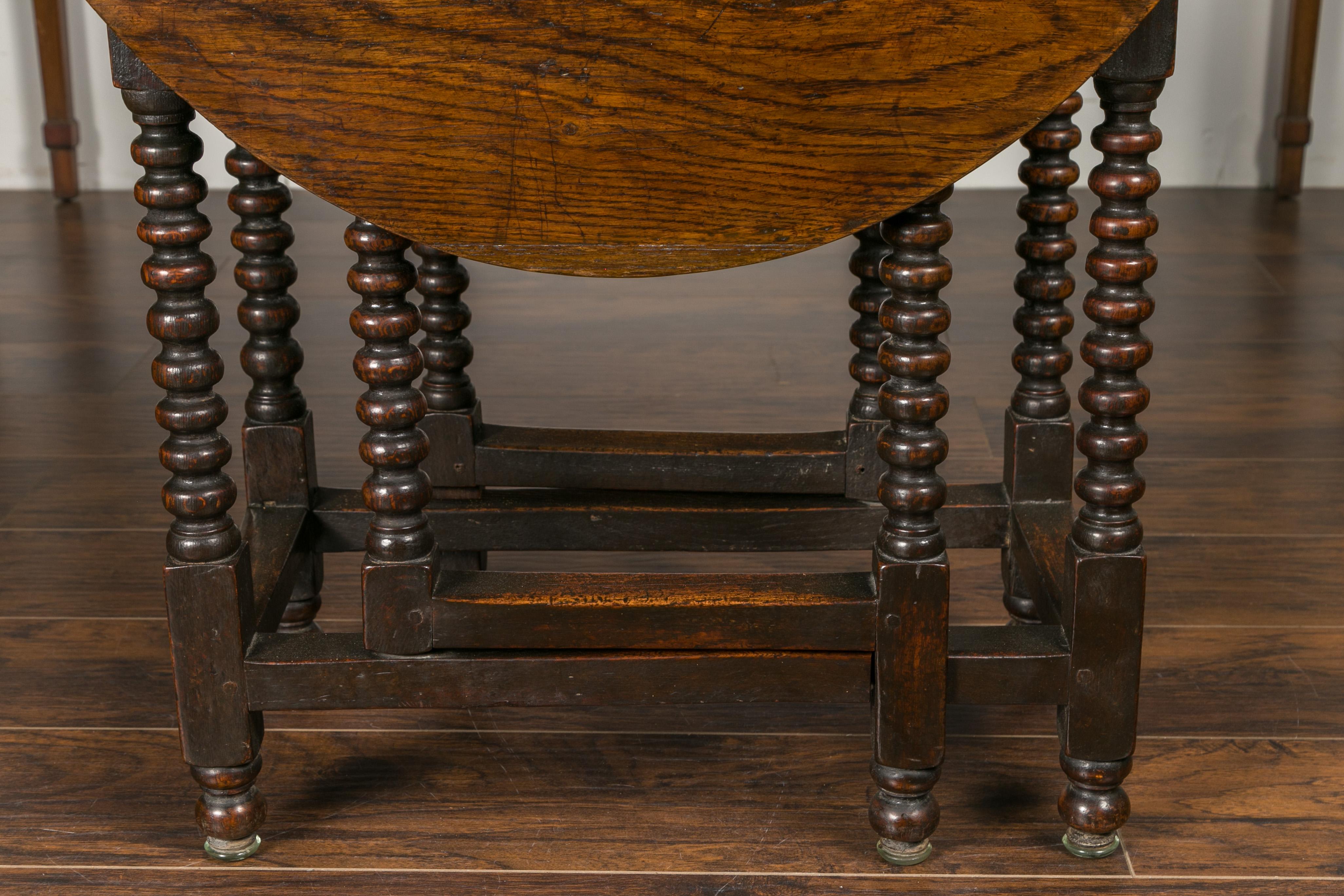 English Oak Bobbin Leg Drop-Leaf Oval Table with Single Drawer and Stretchers In Good Condition In Atlanta, GA