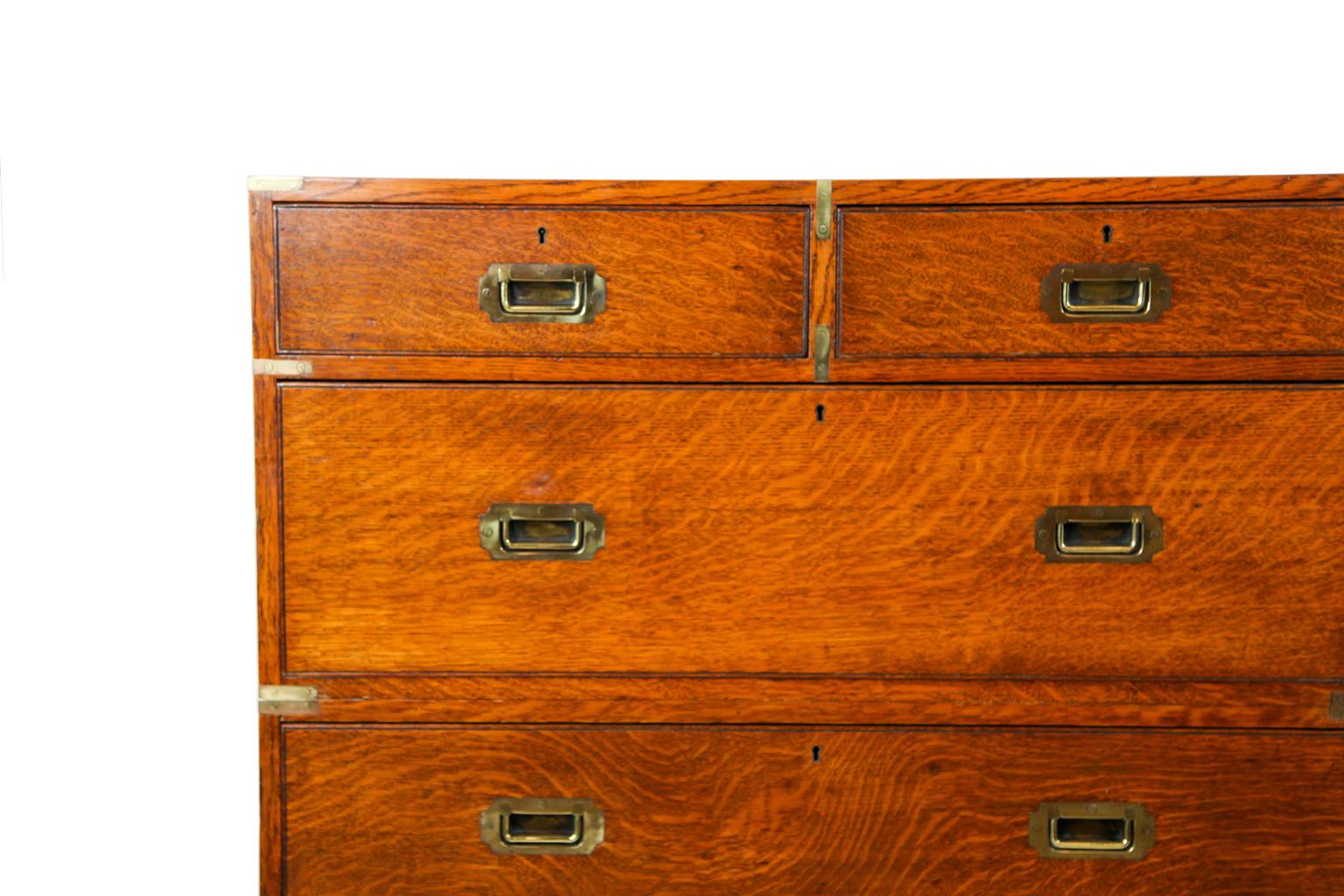 English oak campaign chest, the two section chest with brass top corners and edges, inset Campaign handles, on turned feet.
