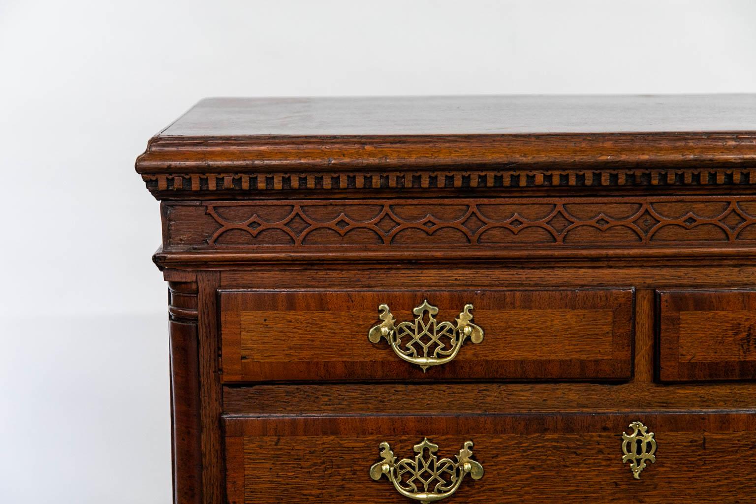 This chest is crossbanded with a mahogany banded on the top and all drawer fronts. The top has heavy ogee molding skirtd with egg and dentil moilding on all three sides. The frieze has a repeating blind fretwork large and small diamond pattern which