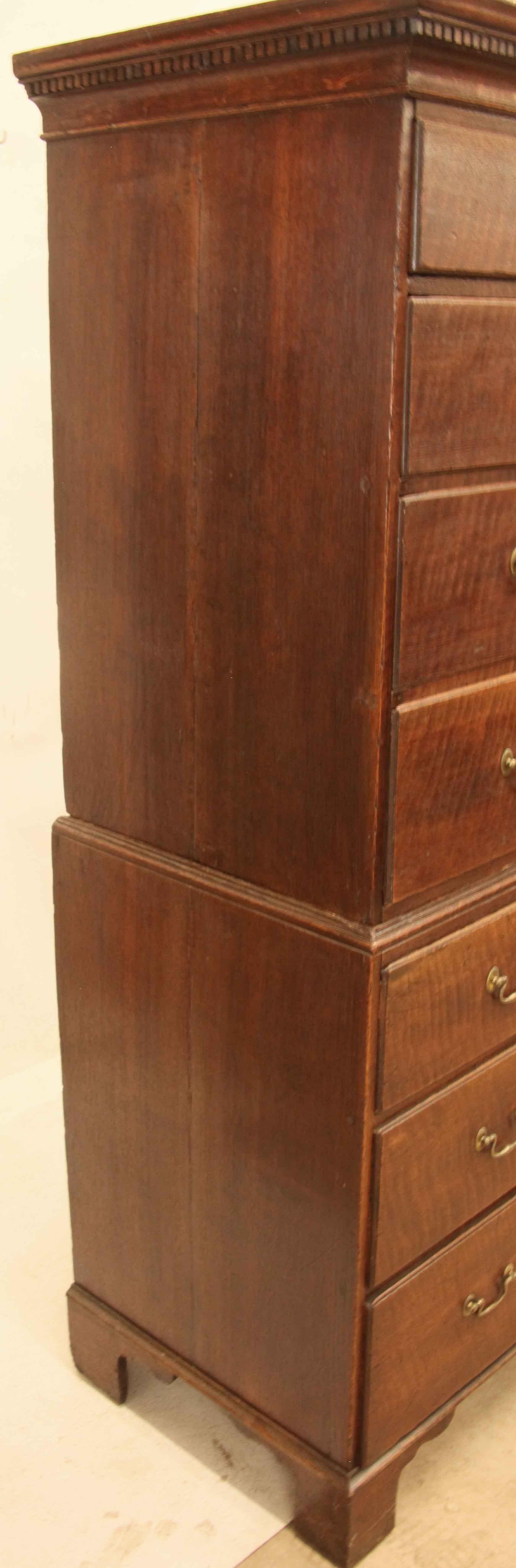English oak chest on chest,  the cornice features dentil molding; the drawers have a pleasant faded color with molded edges (not overlapping) and retain their original swan neck brass pulls with oval back plates, the secondary wood is pine.  This