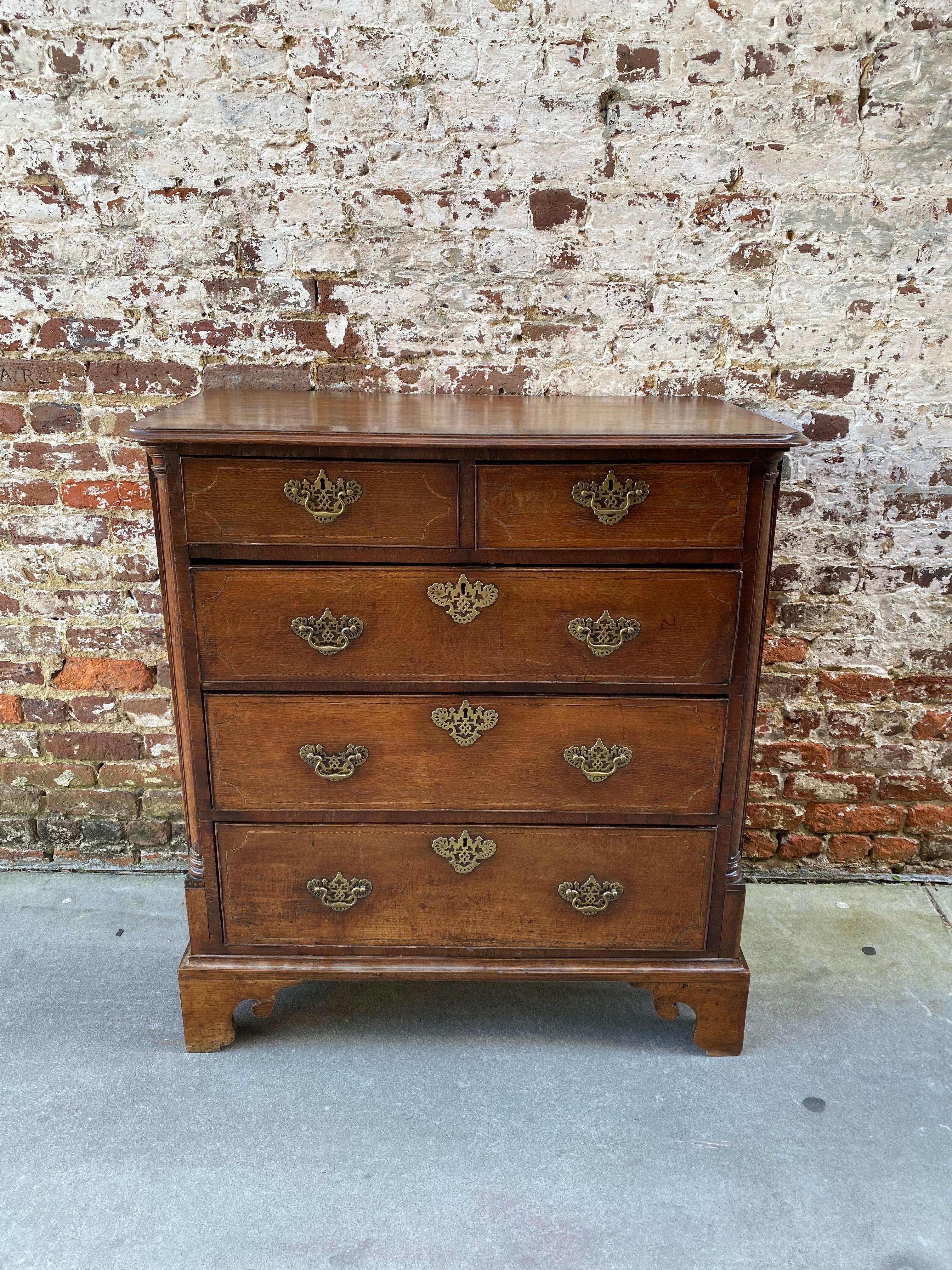English oak inlaid chest with very unique fitted desk in second drawer. Original bracket feet, original pulls, and lovely fitted second drawer desk. The desk has leather writing surface and incorporates several architectural elements in the