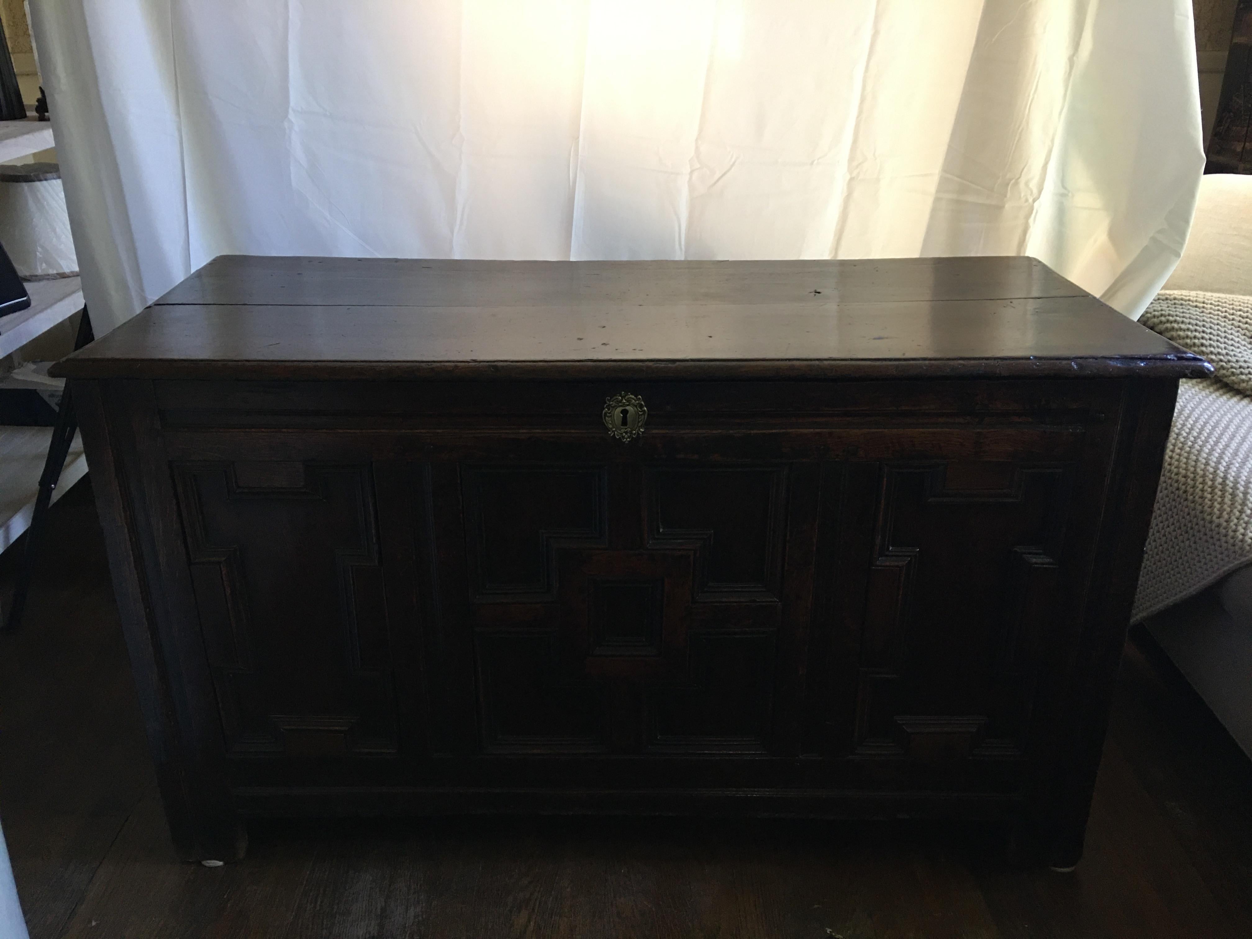 English oak coffer with geometric raised panels on coffer front, circa 1690.