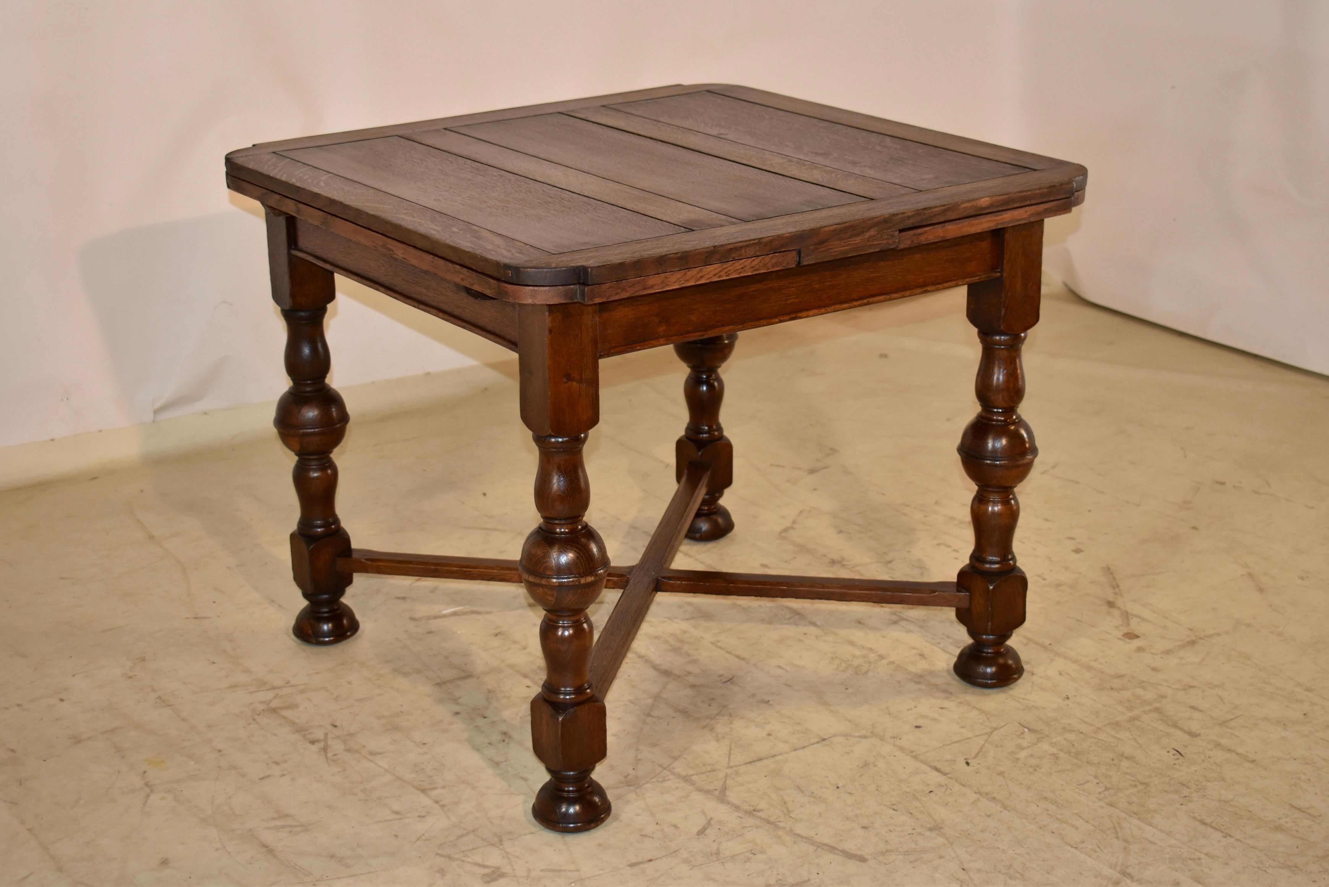 Circa 1900 period Edwardian table with two draw leaves.  The top is paneled as well as the two pull out leaves.  The table measures 59.13 inches when the leaves are fully extended.  The leaves are shaped to fit the shaped edges of the top.  The top