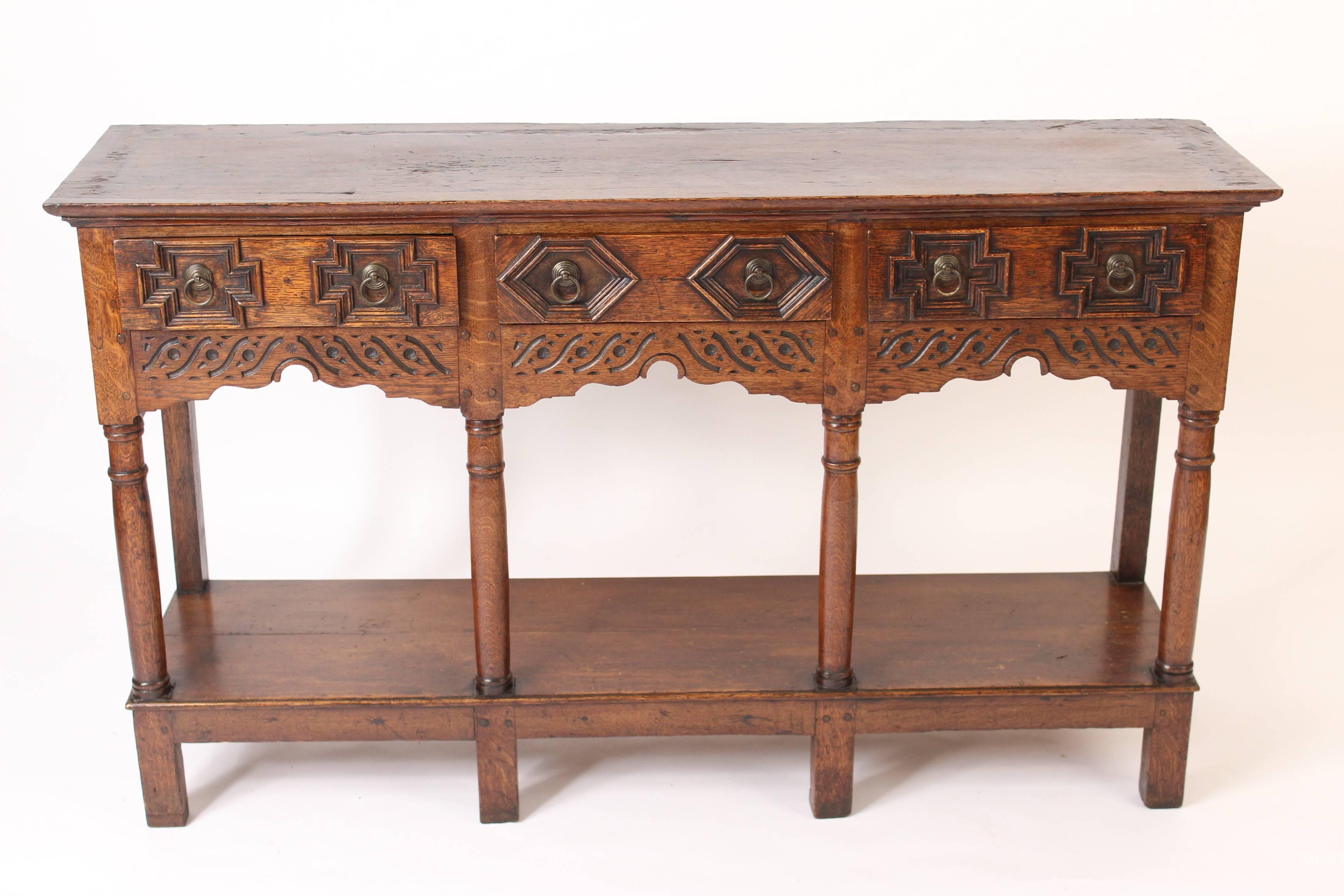 Antique Jacobean style English oak dresser base, 19th century. Nice quality workmanship, good wood color, old period construction, hand dovetailed drawers, mortise, tenon and dowel construction. Hard to find depth of 13.5