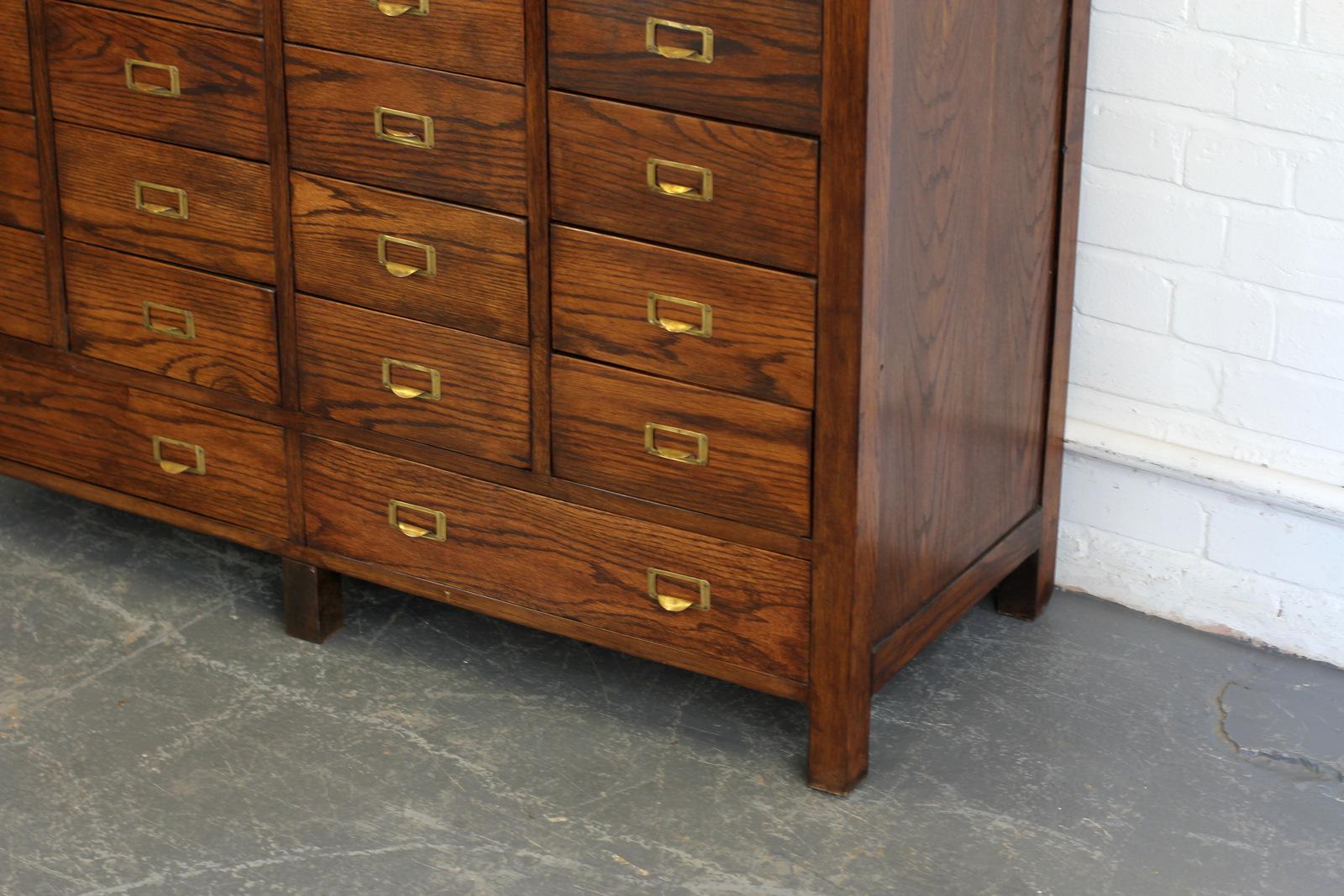 English Oak Filing Drawers, circa 1910 

- Solid oak drawers and frame
- Original brass pull handles
- 20 small drawers and 2 large
- English, Circa 1910
- 130cm wide x 49cm deep x 94cm tall

Condition Report

The cabinet has been fully