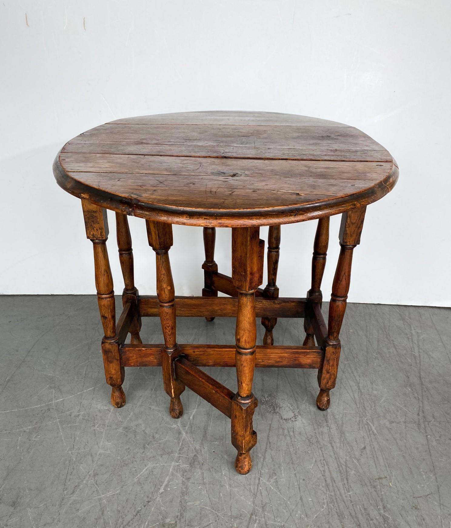 An oval-shaped drop-leaf gate-leg table. 
Size 40.70