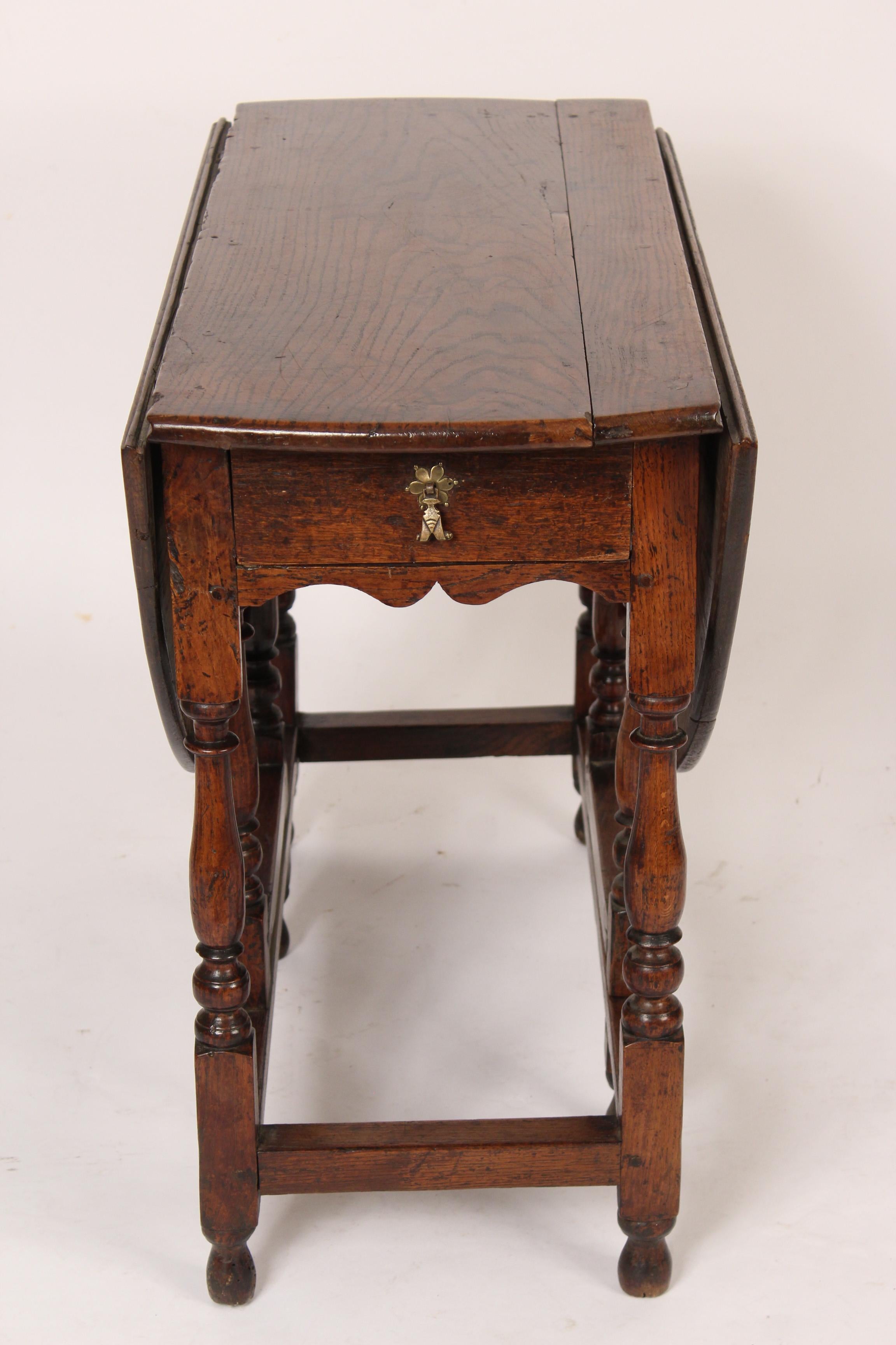Antique English oak gate leg table, early 19th century. Each drop leaf is 16