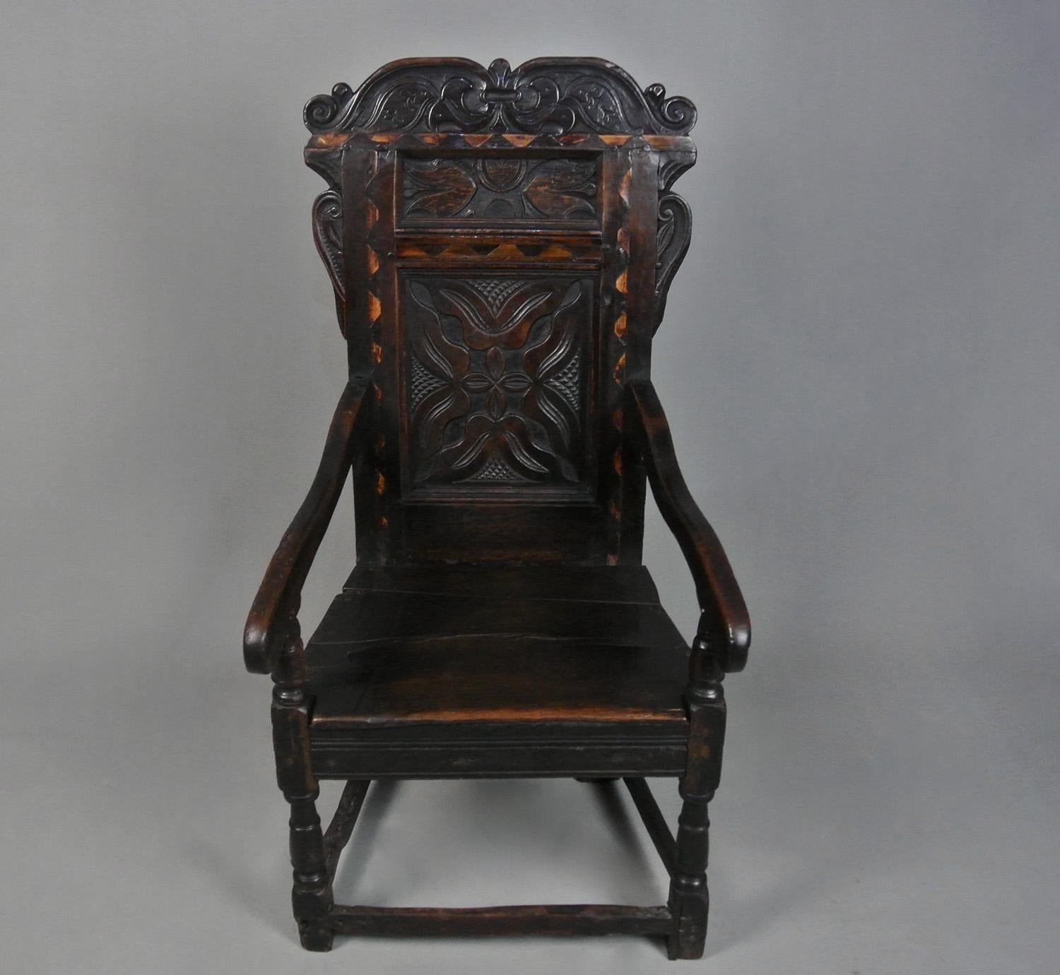 A very fine mid 17th Century oak wainscot ‘Great Chair’ made by a skilled hand and probably from  the Leeds area with a beautiful naturally developed rich colour to the oak, good patination, pegged joints and well carved crest rail and ears.
  
The