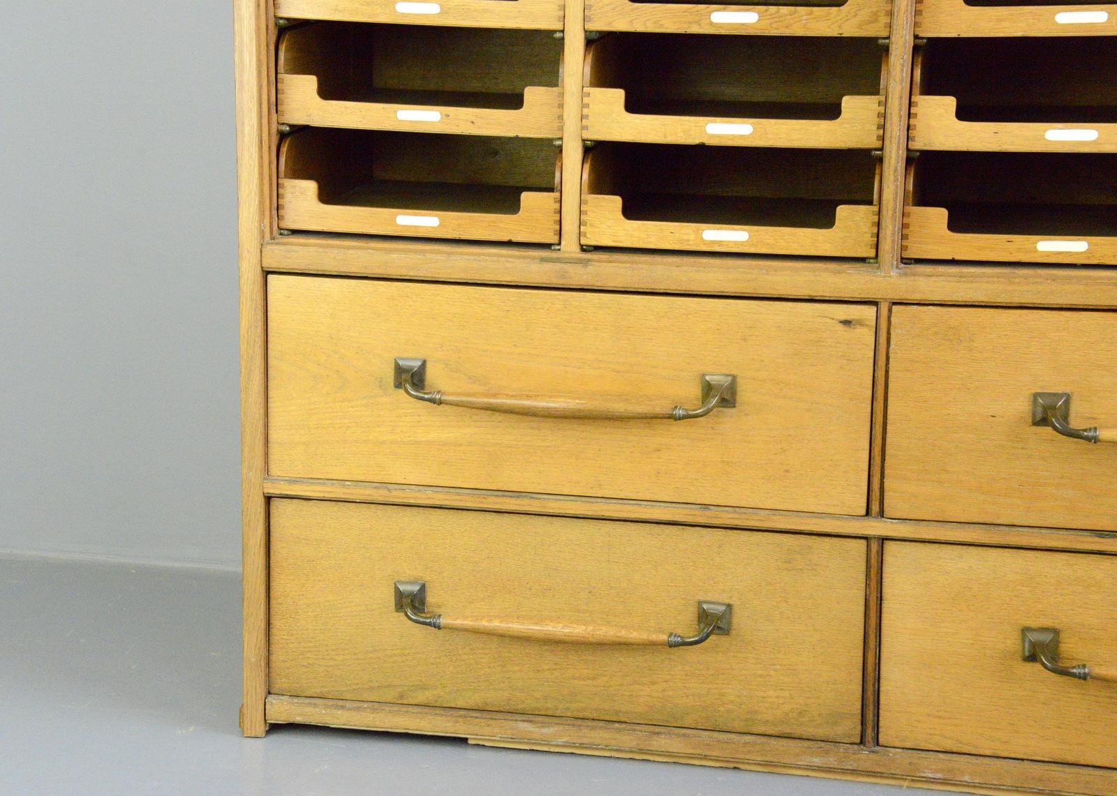 English oak haberdashery cabinet, circa 1920s

- Oak frame and drawers
- 4 large drawers with oak and cast bronze handles
- 36 smaller drawers
- Lift down windows
- Oak veneer sides
- English, 1920s
- Measures: 152cm wide x 192cm tall x 52cm