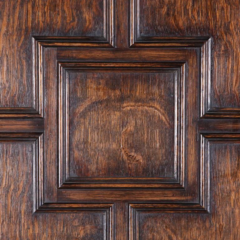 An English oak Tudor style single door hall wardrobe, the paneled door opening to reveal an interior for hanging coats.