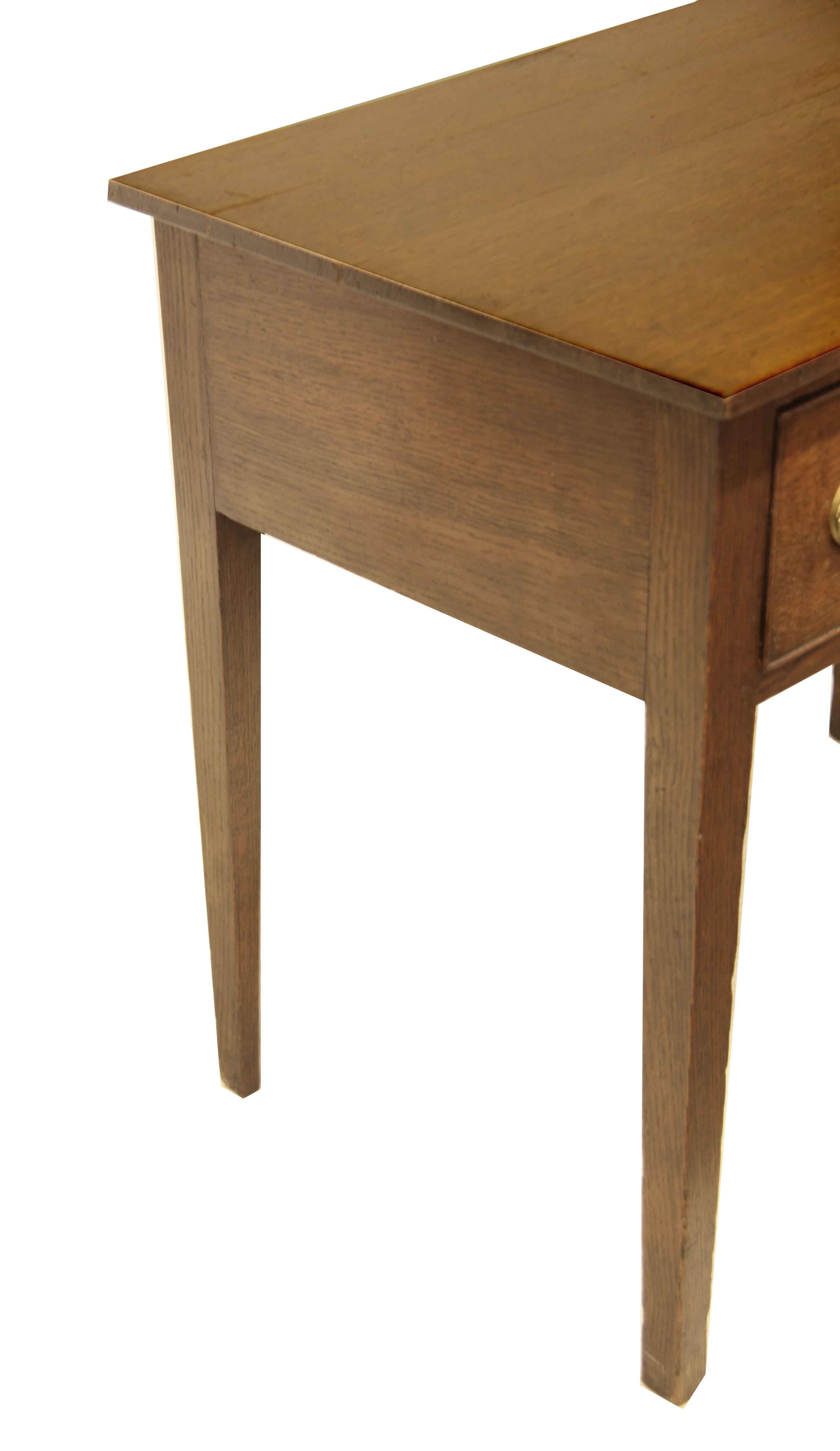 English oak Hepplewhite lowboy,  pleasant color and patina throughout this early 19th century lowboy; the oval ''urn'' brass pulls are correct for the period and the piece but are not original.  The legs are nicely tapered and well proportioned with