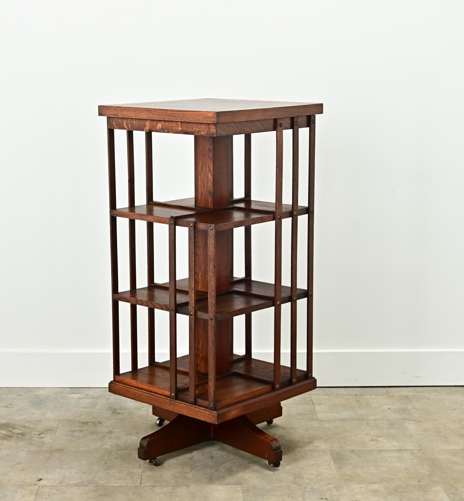 An English revolving bookcase is perfect for your interior. This oak bookcase has three sessions for books no more than 10” tall. The open cabinet sits over a four leg base lifted on casters. Cleaned and polished with a paste wax this interesting