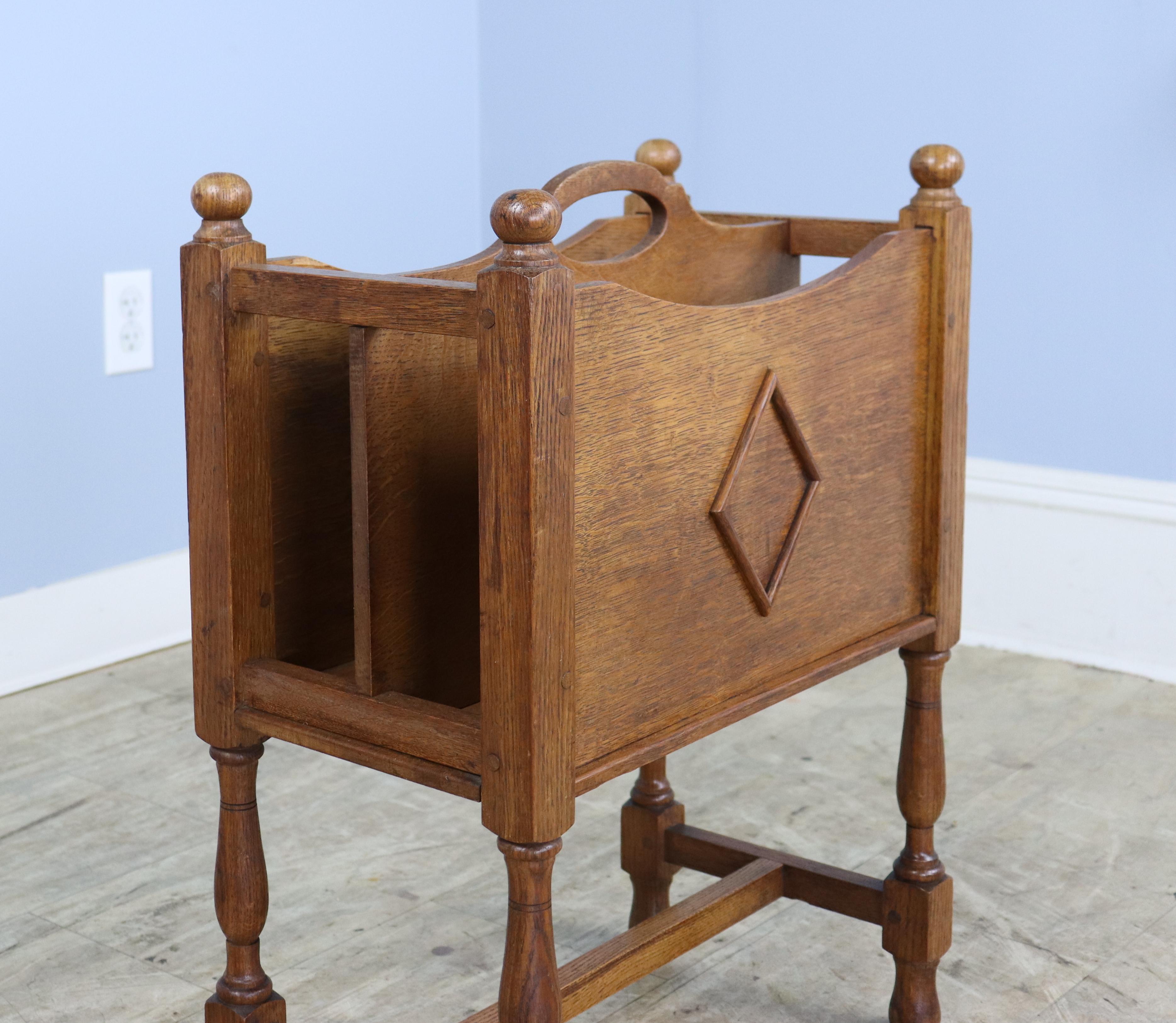 A versatile sheet music or magazine rack in rich Golden Oak.  The raised diamond motif is on both sides, each pictured.  Height measurement includes the finials.