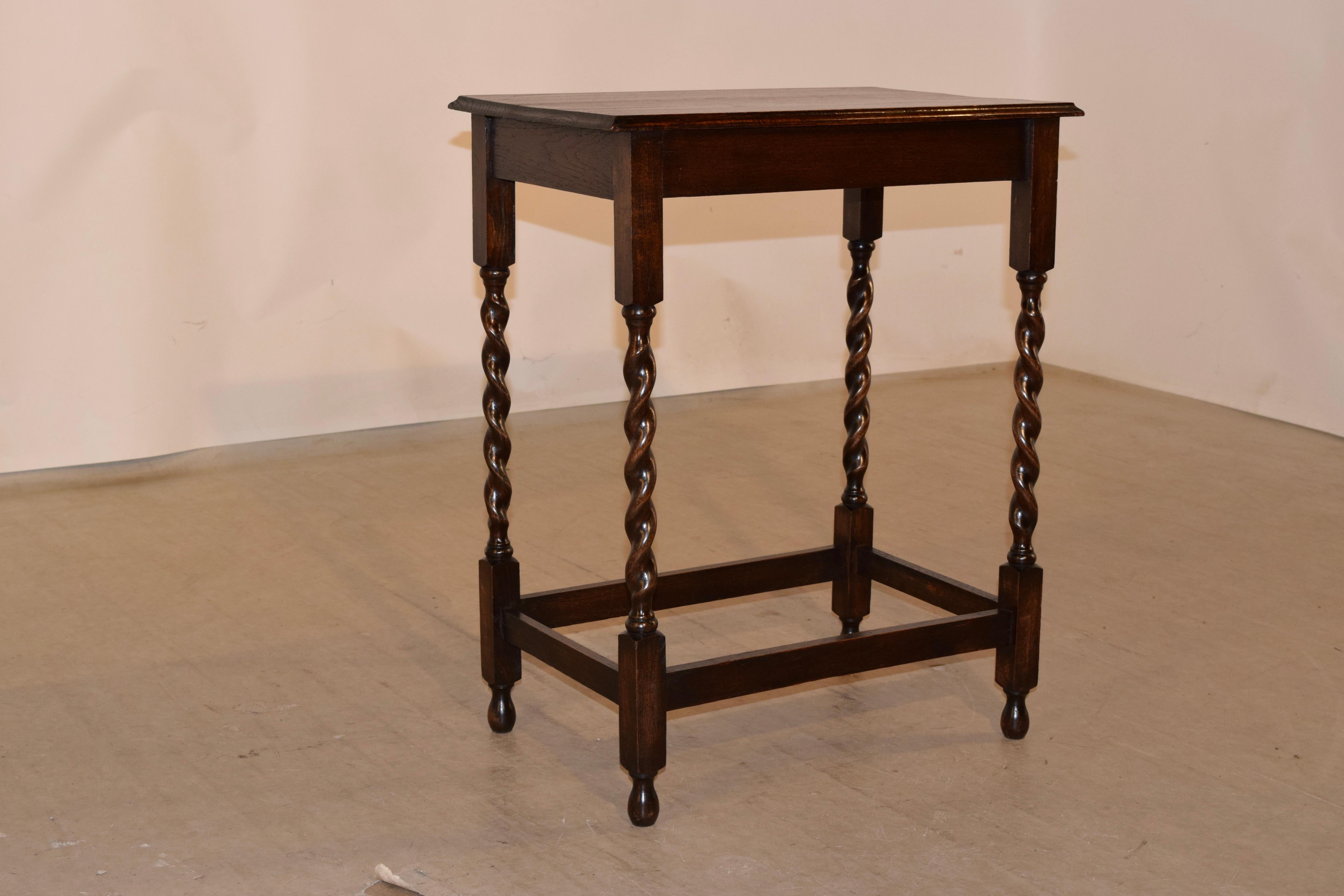 English oak side table with a beveled edge around the top and a simple apron, supported on hand-turned barley twist legs joined by simple stretchers and raised on turned feet, circa 1900.
 
  