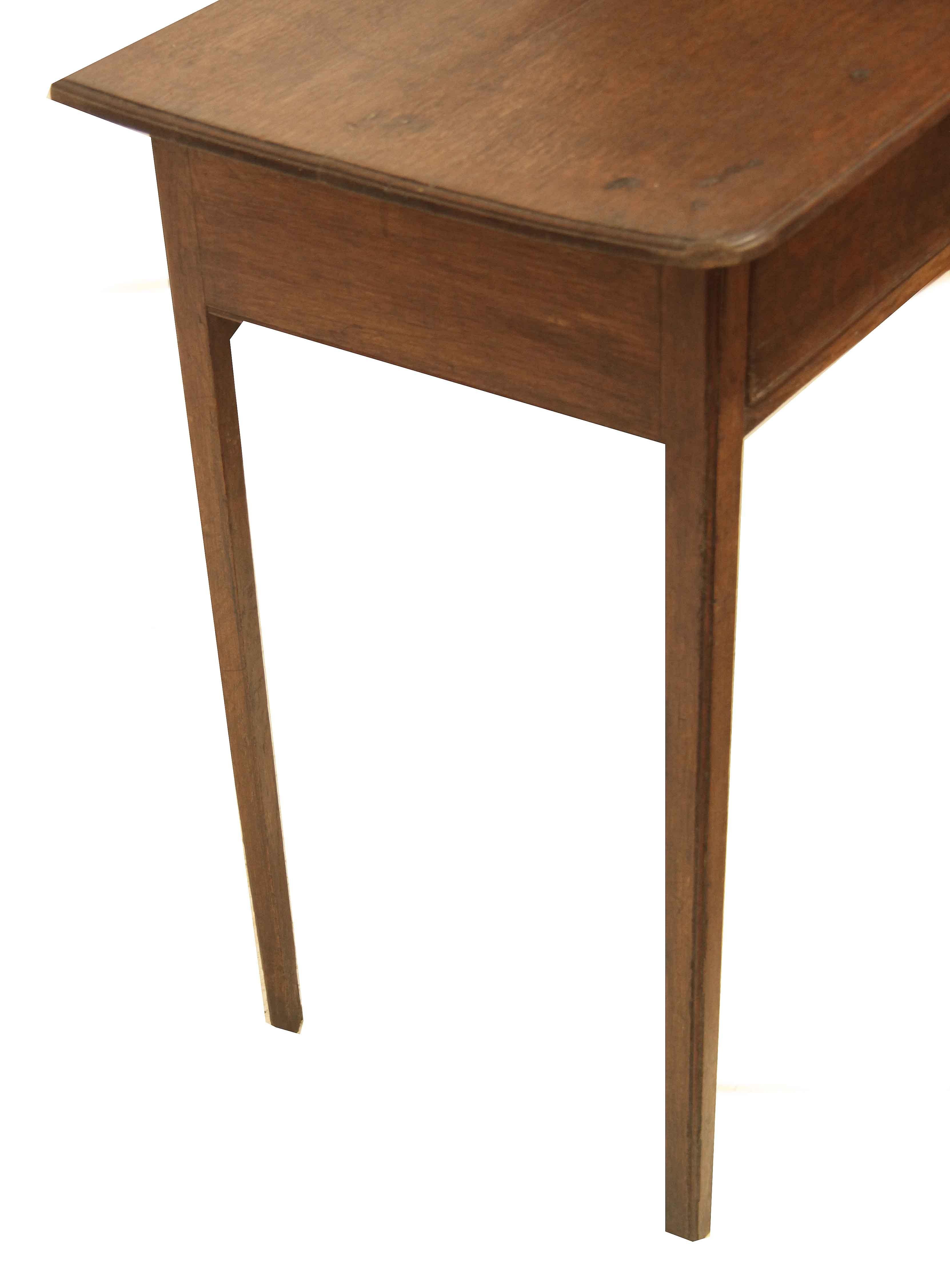 English oak side table, with excellent color and patina, the top has rounded front corners and a molded edge shaped from the top(not applied molding); the single drawer retains the original swan neck pull and raised escutcheon. The delicate but