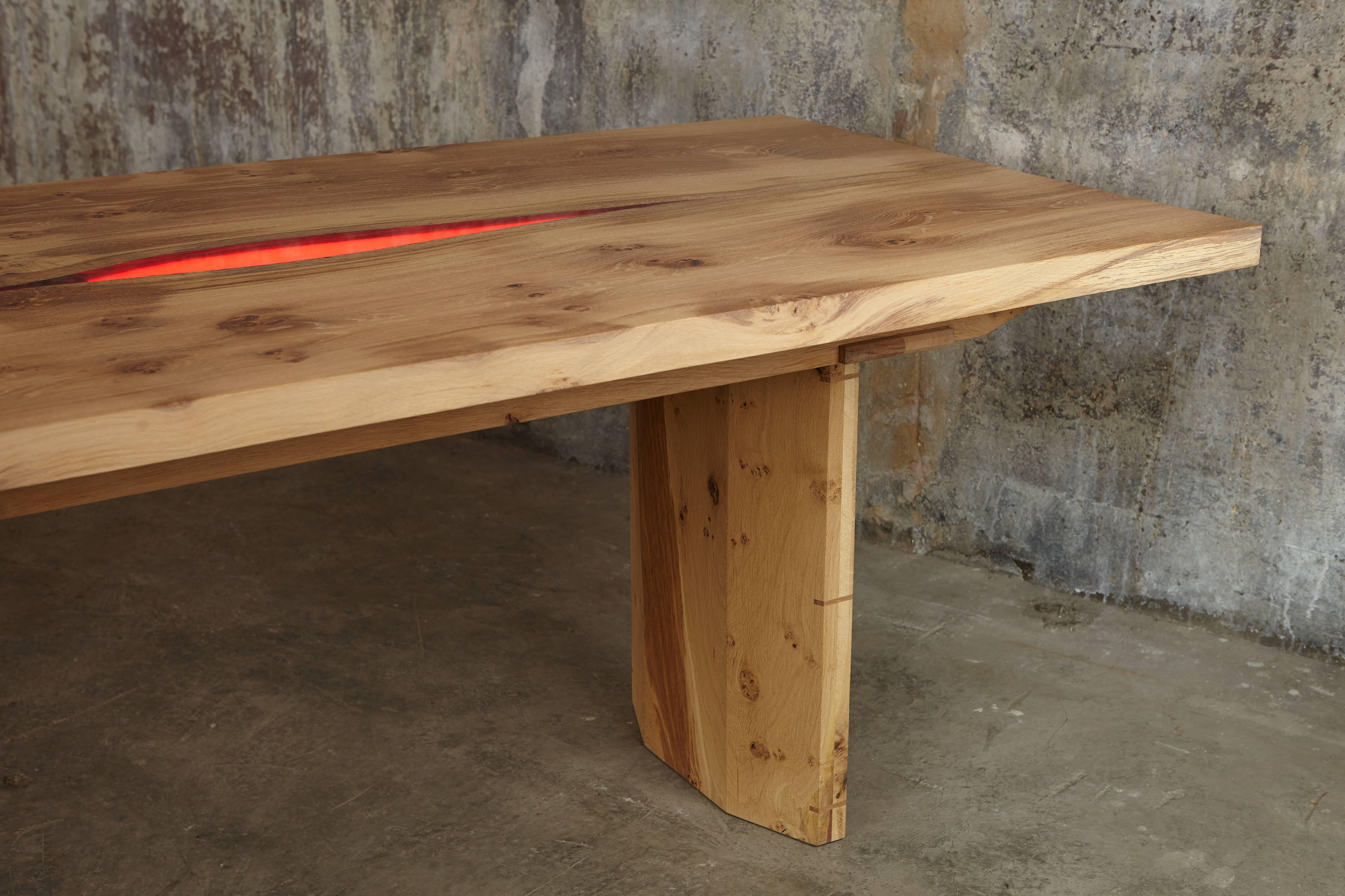 Made from solid English oak. The two tables are designed to sit end to end giving a total length of 5.2 metres / 17ft or positioned apart. The book-matched inverted live edge central section has been infilled with a clear resin which is backlit with