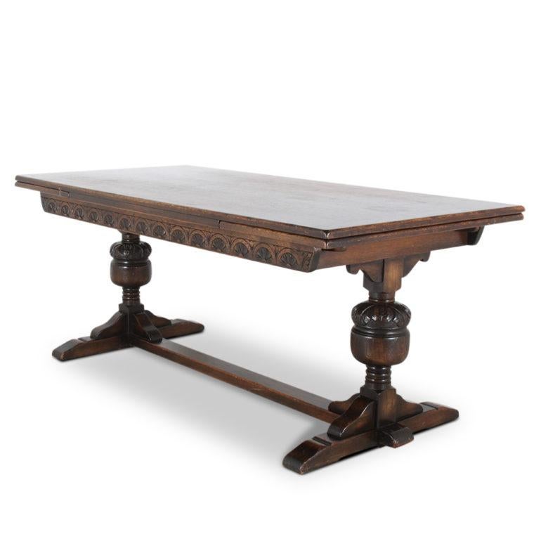 An English oak ‘draw-leaf’ trestle table with carved turned double pedestal base, circa 1930.

Measures: 72? wide x 35? deep x 30? tall (+ 2 x 18? leaves, maximum table length 108?).

 