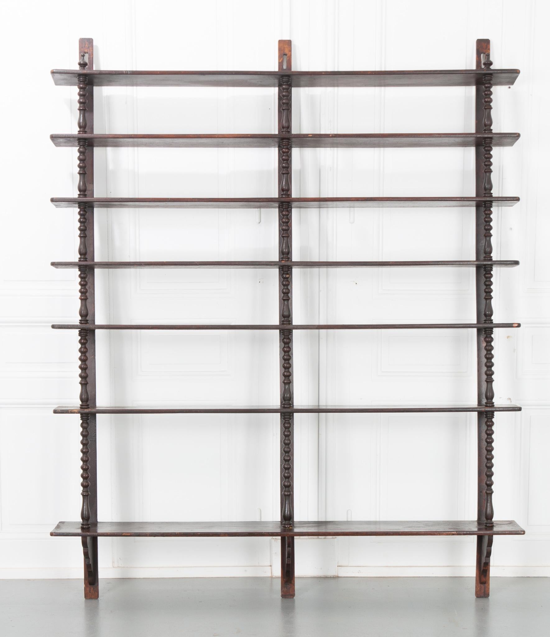 This wall shelf is massive! Made of solid oak it has seven shelves for a ton of storage or display surface area. Standing at over 6 feet tall it’s a perfect piece if you’re looking for floor-to-ceiling shelves. The turned wooden supports in the