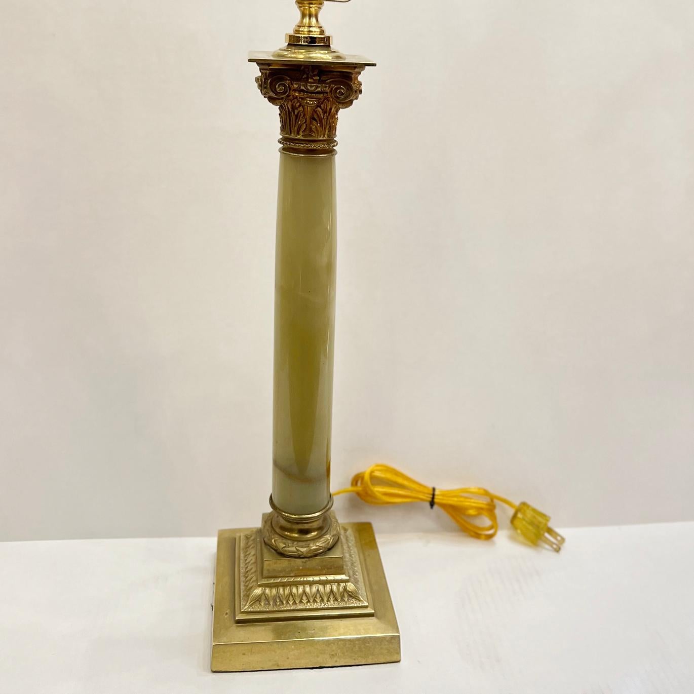 A single circa 1920's neoclassic onyx and gilt bronze table lamp.

Measurements:
Height of body: 17.25