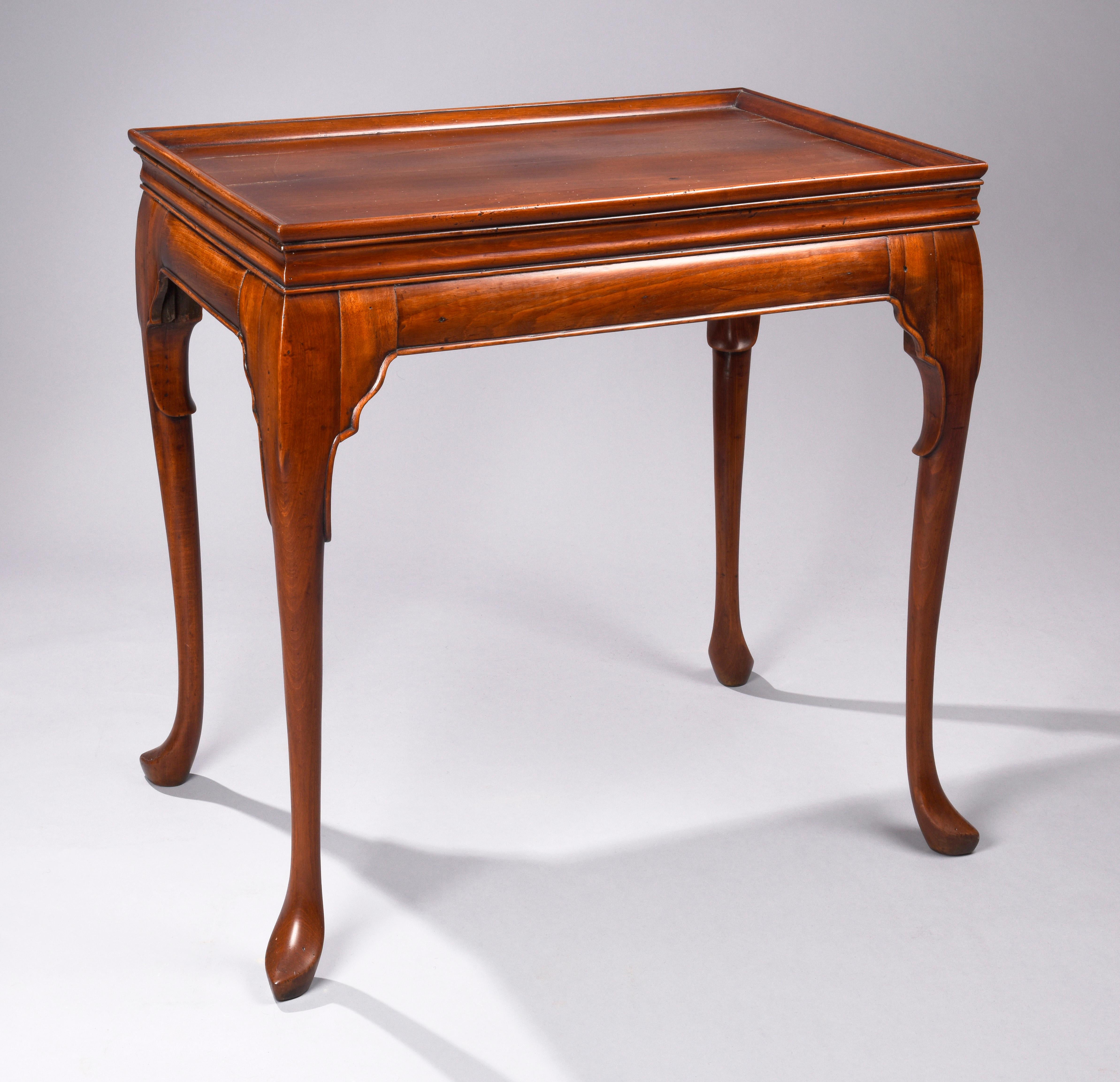 English or Irish tray top tea table with raised molding on the aprons and moving down knees. Finely detailed and bold moldings around the tray. Cabriole legs terminating in slipper feet, circa 1740-1760.