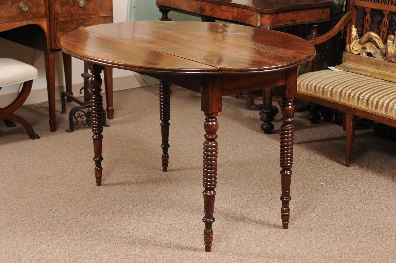The mid-19th century mahogany breakfast table with oval top, drop leaves and bobbin turned legs. 

The dimensions are 51