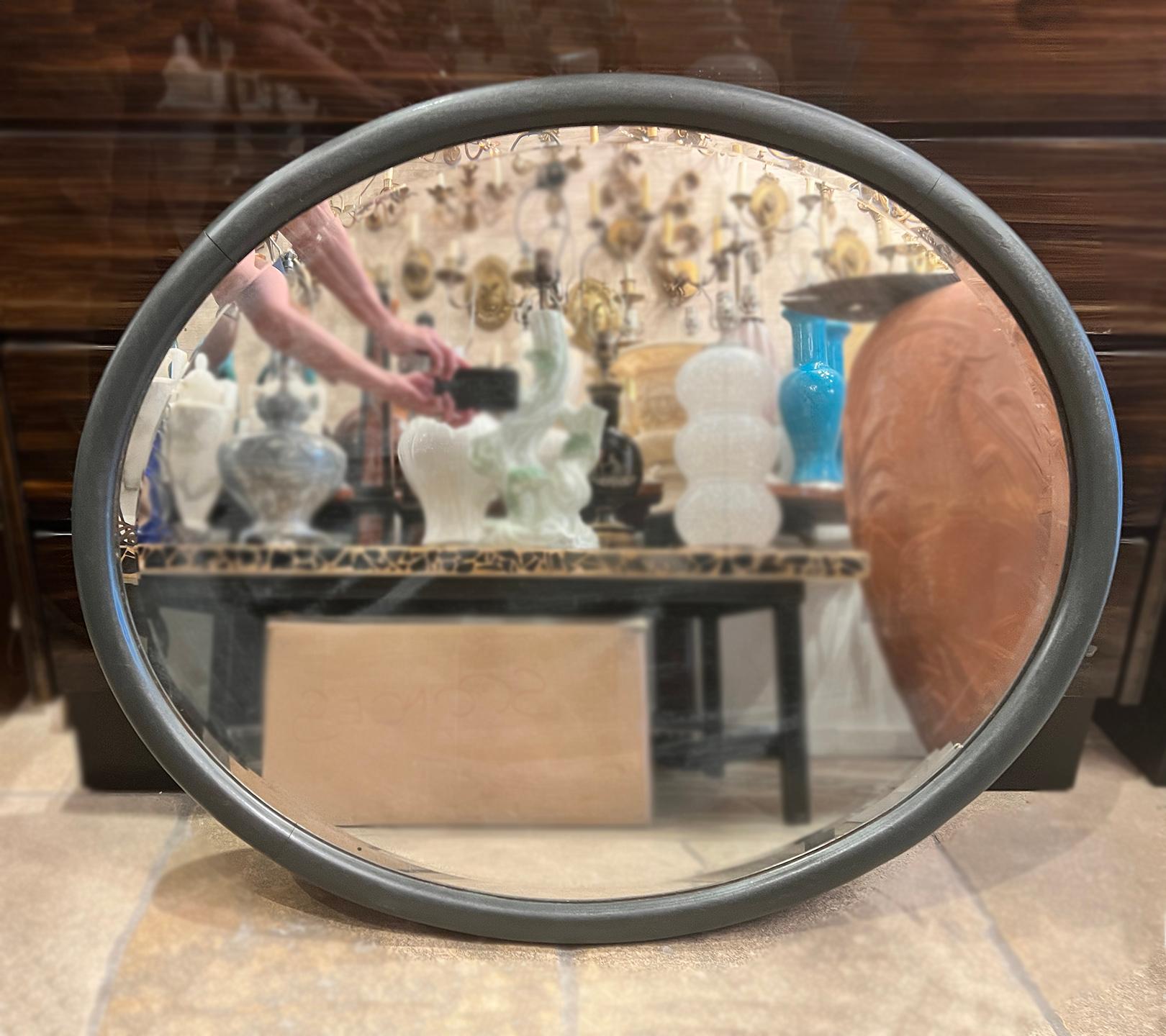 A circa 1920's oval English mirror.

Measurements:
Height: 36