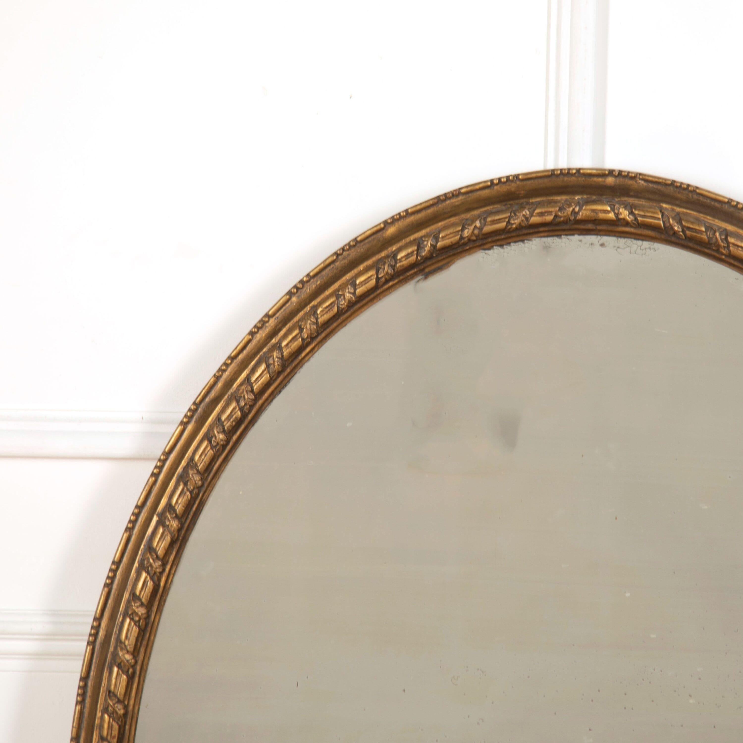 English 19th century oval gilded mirror, circa 1860.