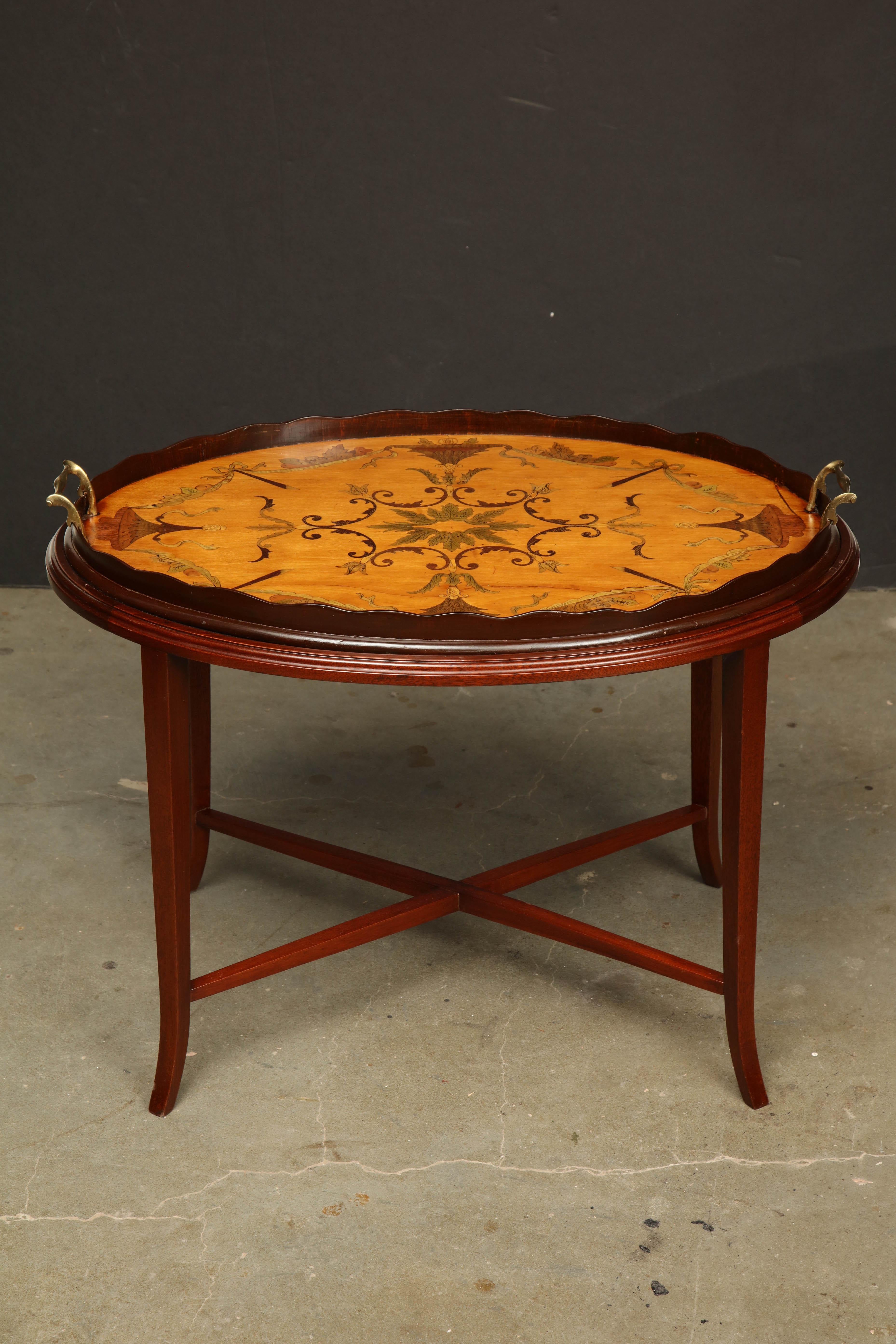 A fine English satinwood tray with elaborate marquetry neoclassic decoration, scalloped wooden gallery and brass handles. On a later X-stretcher base stand.