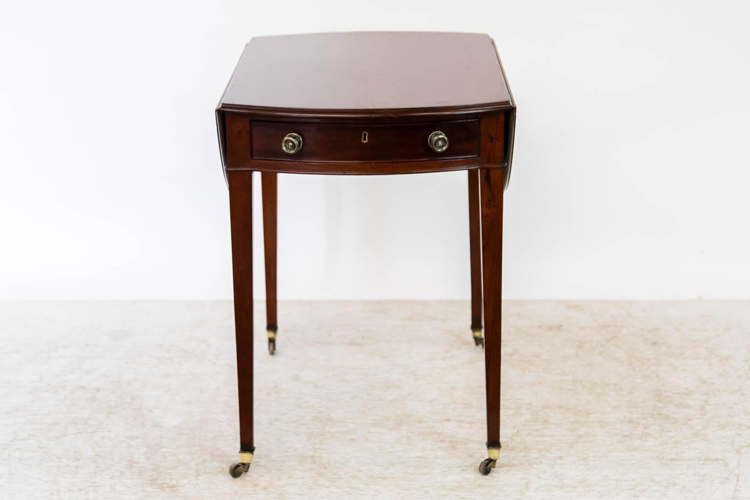 This pembroke table has a one board top in the center over 20 inches wide with no cracks or shrinkage separations. There is a working drawer at one end with a matching dummy front on the opposite end. All of the hardware and castors are original.