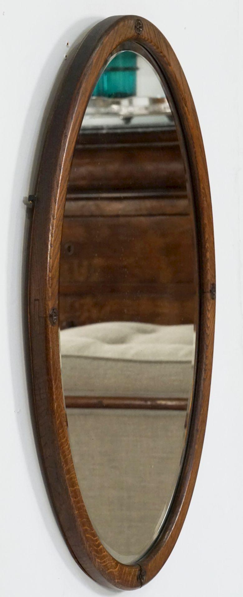 A fine English oval parlour wall mirror from the Edwardian era, with a handsome oak frame inset with a beveled mirror.

Can be displayed vertically or horizontally.

Dimensions: H 27 3/4 inches x W 18 inches x D 1 inch.