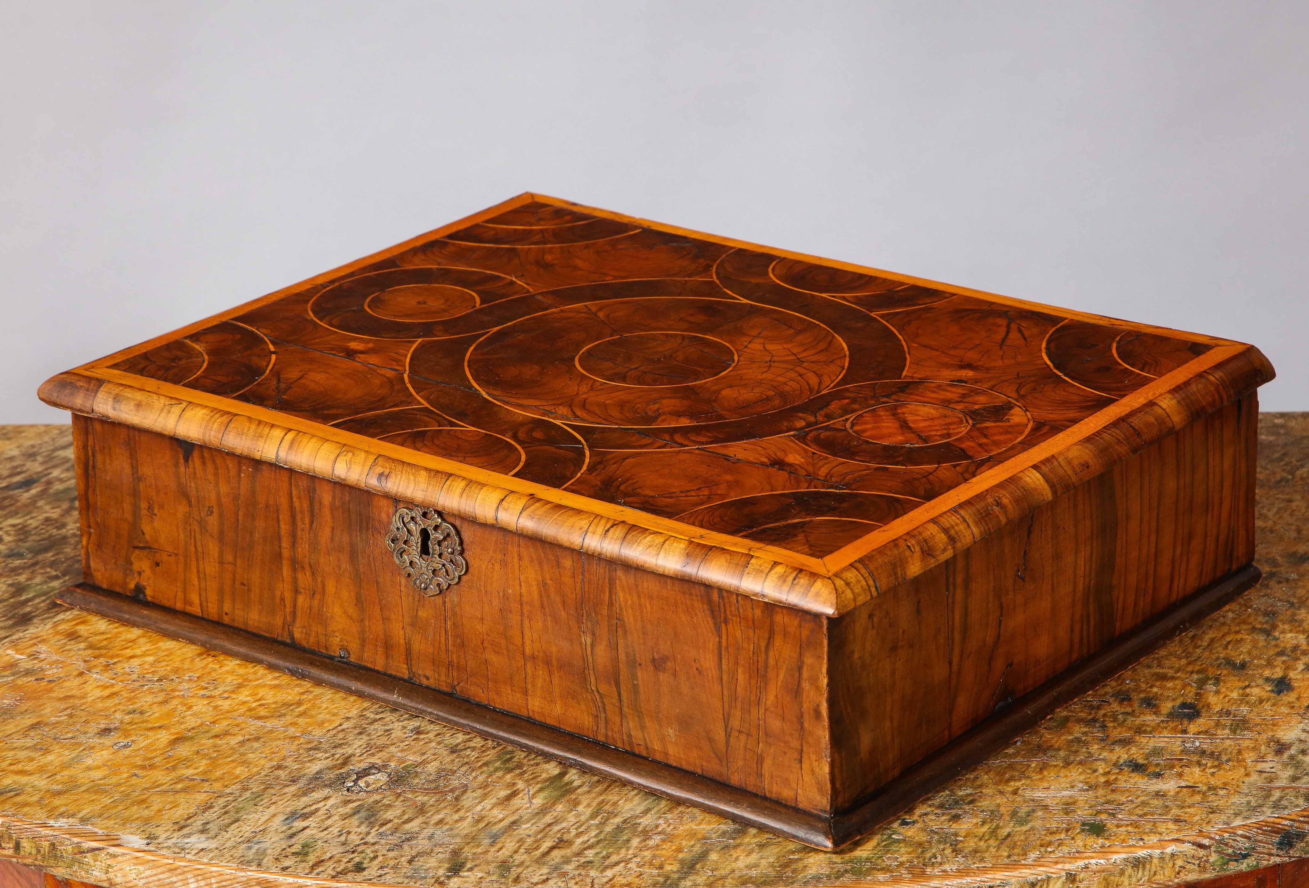 Very fine William and Mary period English walnut oyster veneered glove or document box with geometrically patterned oysters with boxwood inlay, old painted interior surface, possessing good rich color and patination.
 
