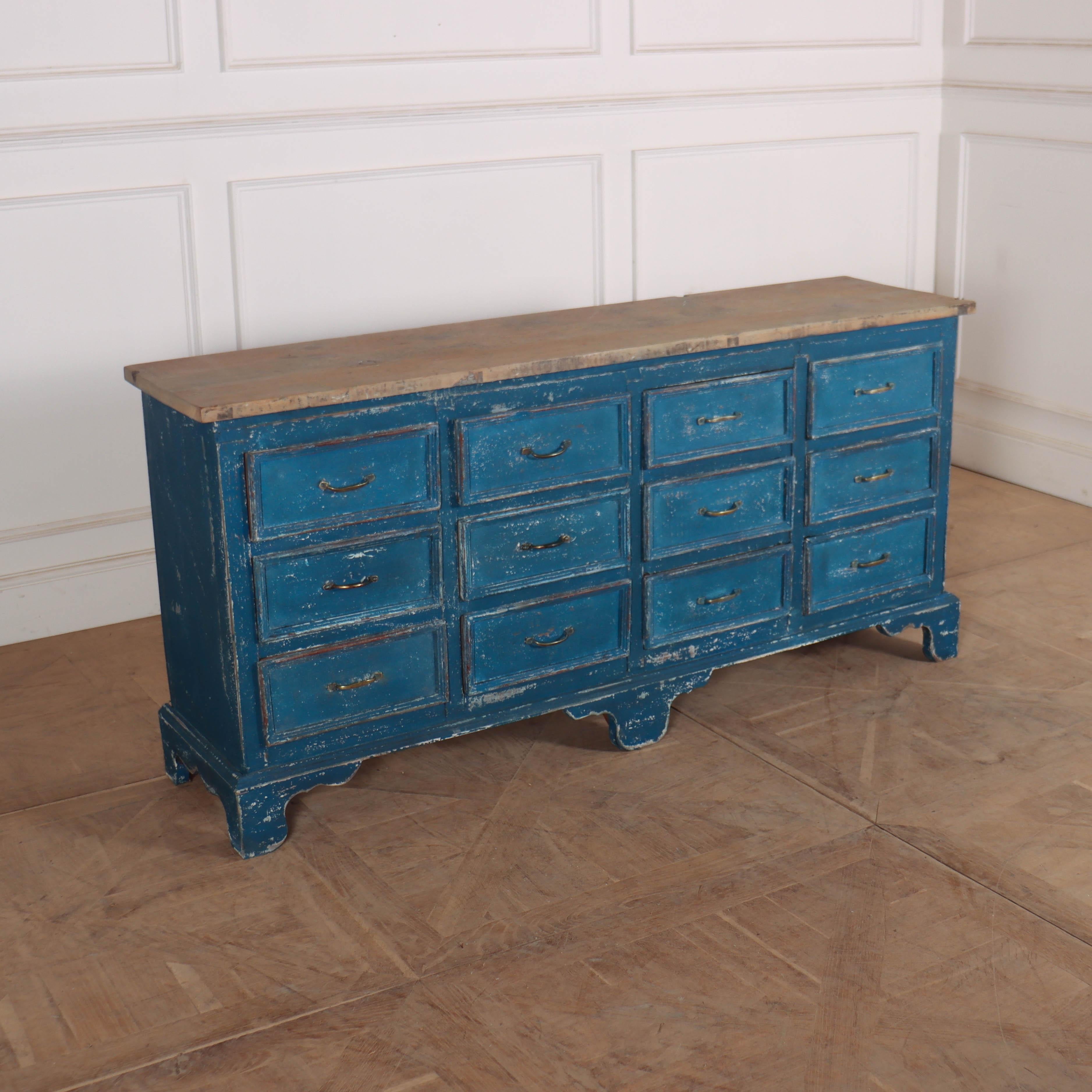 Good late 19th C English painted pine base of 12 drawers from a haberdashery shop. 1890.

Dimensions
67 inches (170 cms) Wide
17 inches (43 cms) Deep
32 inches (81 cms) High.