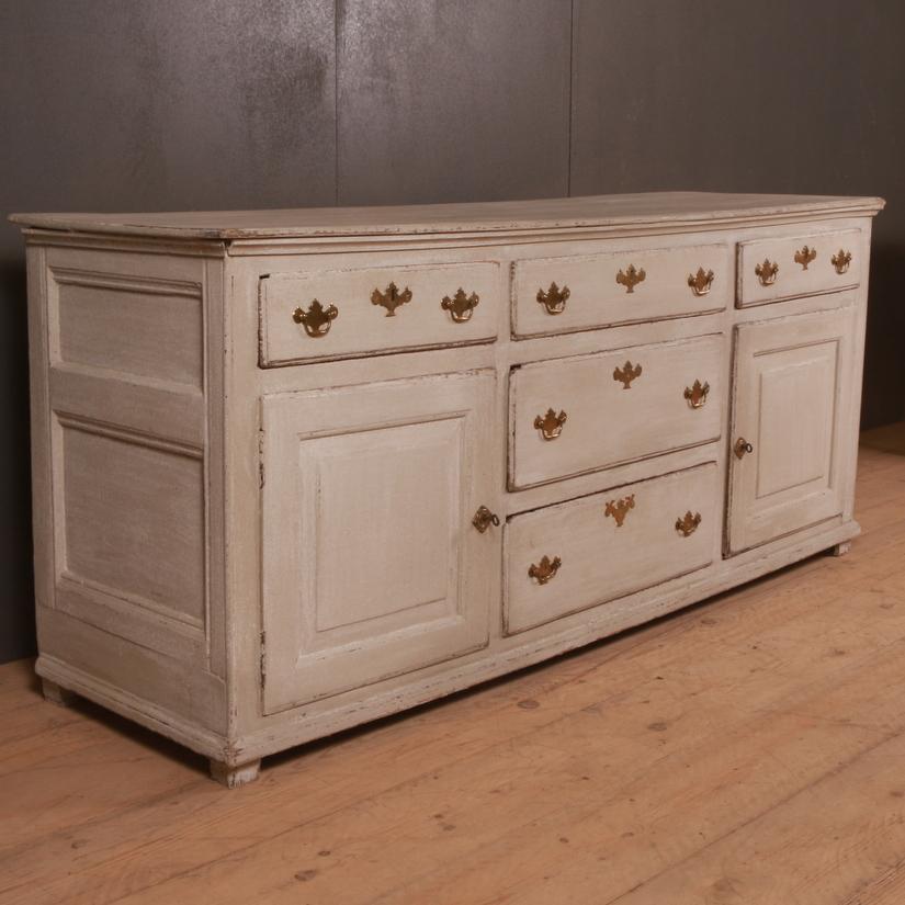 Mid-18th century English painted dresser base, 1760.

Dimensions:
71.5 inches (182 cms) wide
21.5 inches (55 cms) deep
31 inches (79 cms) high.

 