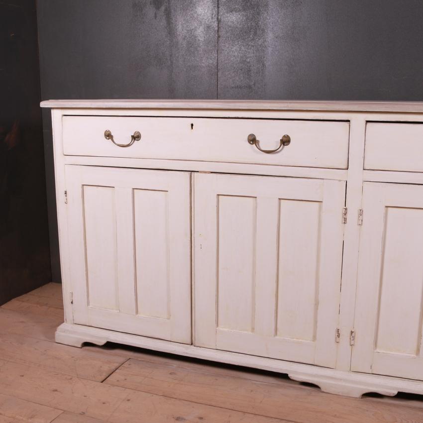 Large narrow English painted dresser base, 1840.

Dimensions
94 inches (239 cms) wide
17 inches (43 cms) deep
40 inches (102 cms) high.