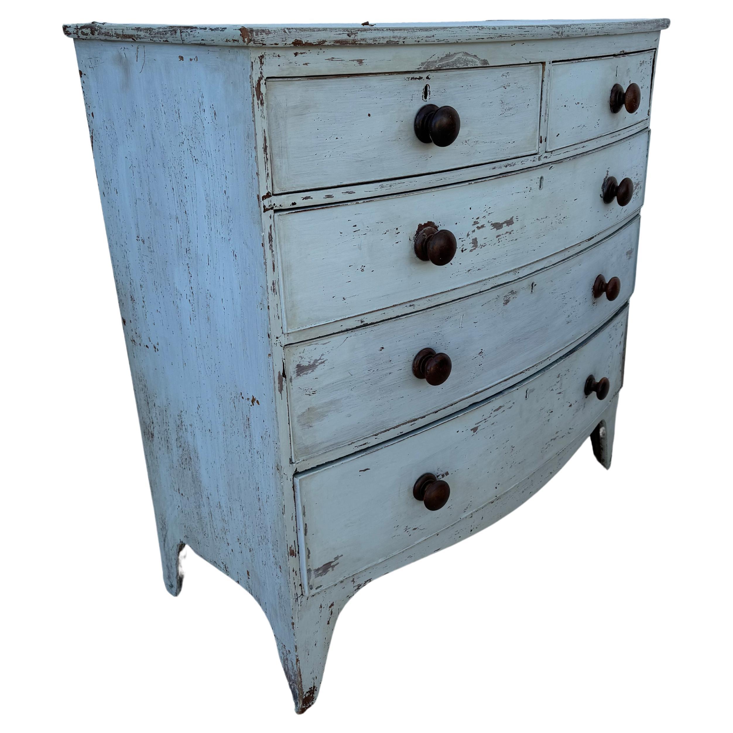 19th Century English painted bowfront chest of drawers with wooden handles. Chest features two small drawers on top of three spacious drawers. Painted light blue. Perfect chest to be used in any room of your home. Wonderful old patina.