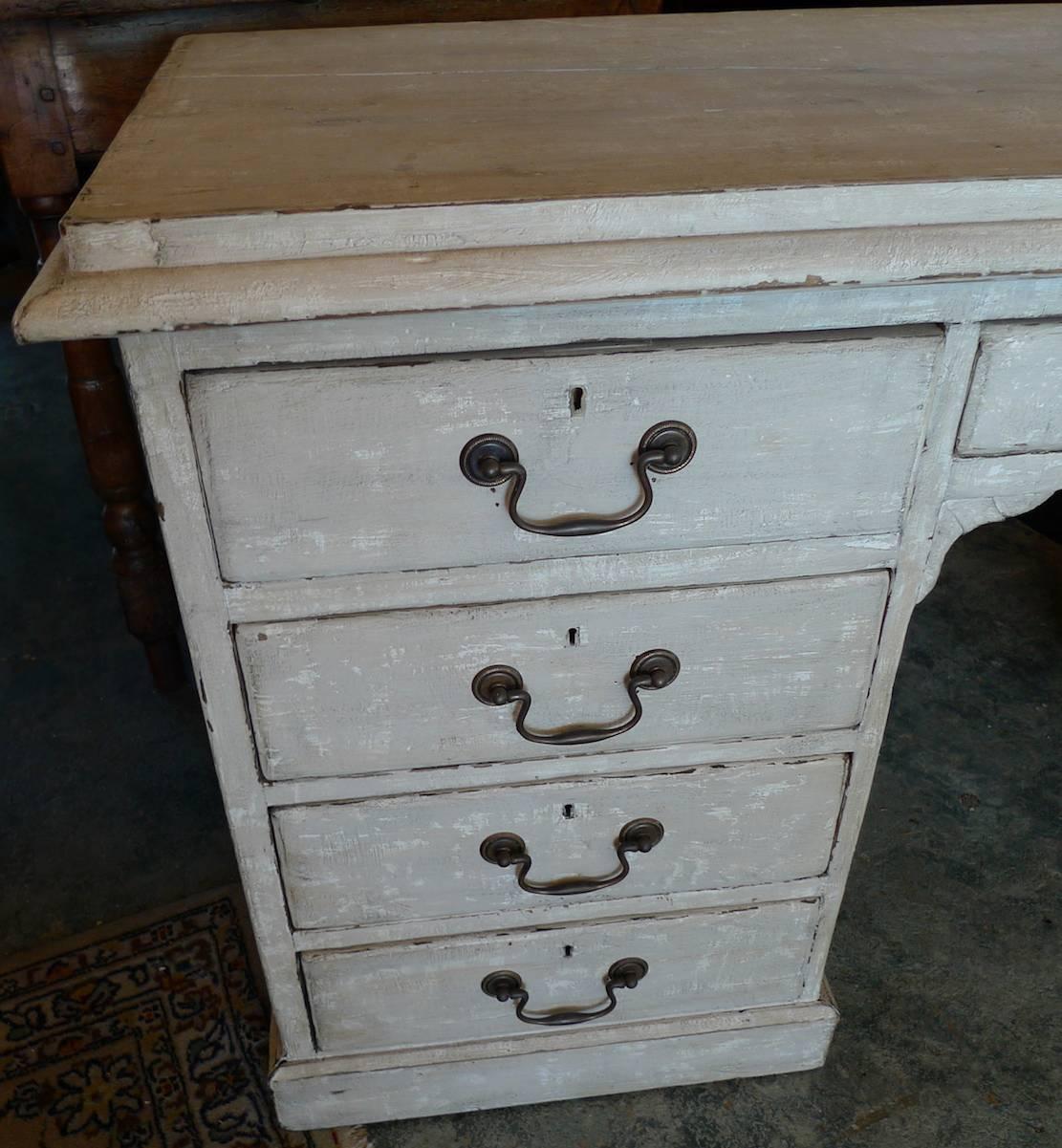 English 19th century hand painted knee-hole writing desk with nine drawers and original hardware.
 
