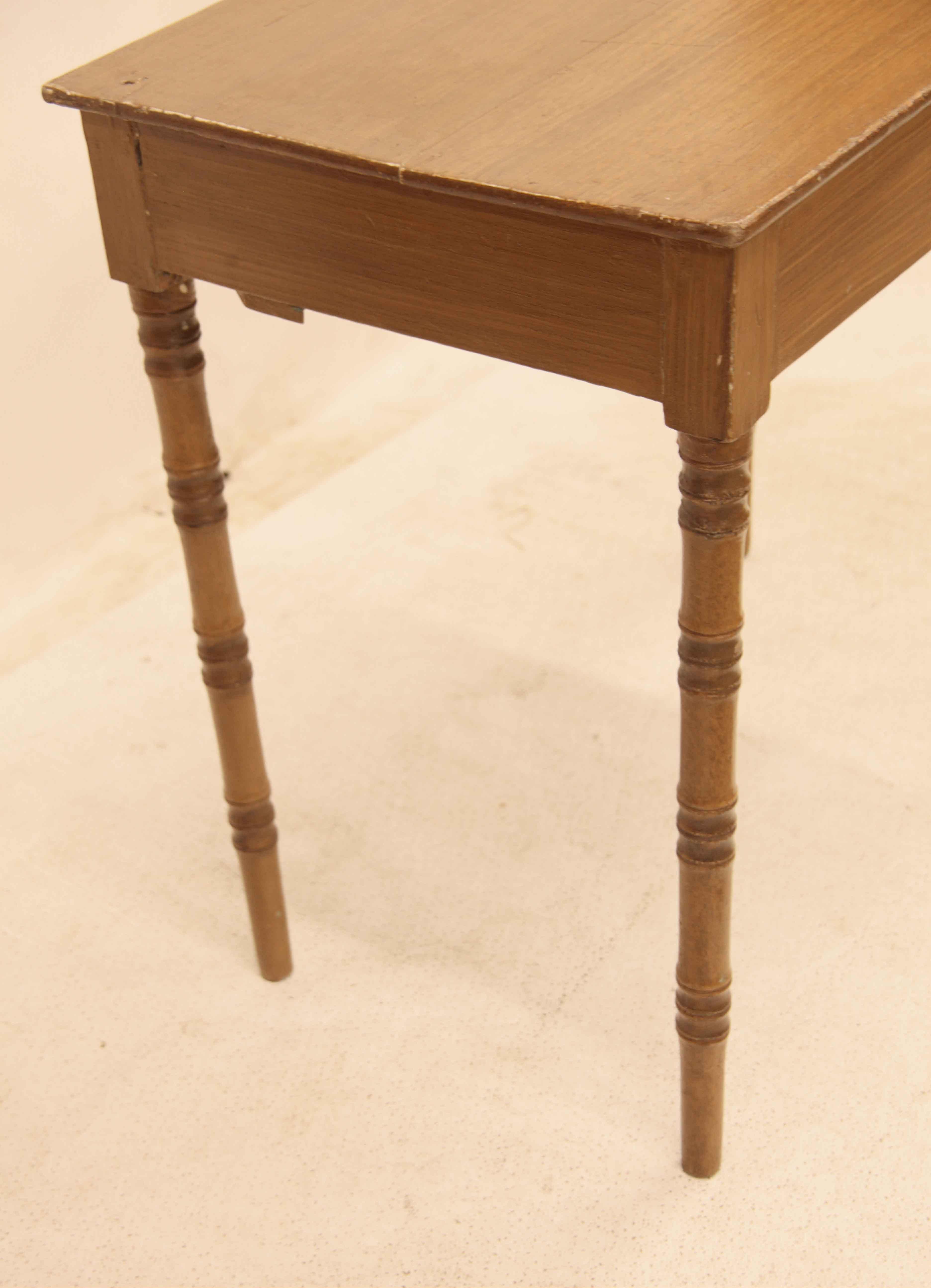 English painted one drawer table,  this table is painted or glazed with a warm faded mahogany color which is very pleasing to the eye, it features delicately turned legs that resemble bamboo.  The single center drawer has a swan neck pull and oval