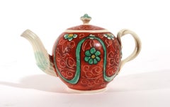 English Painted Orange-ground Creamware Teapot and Cover