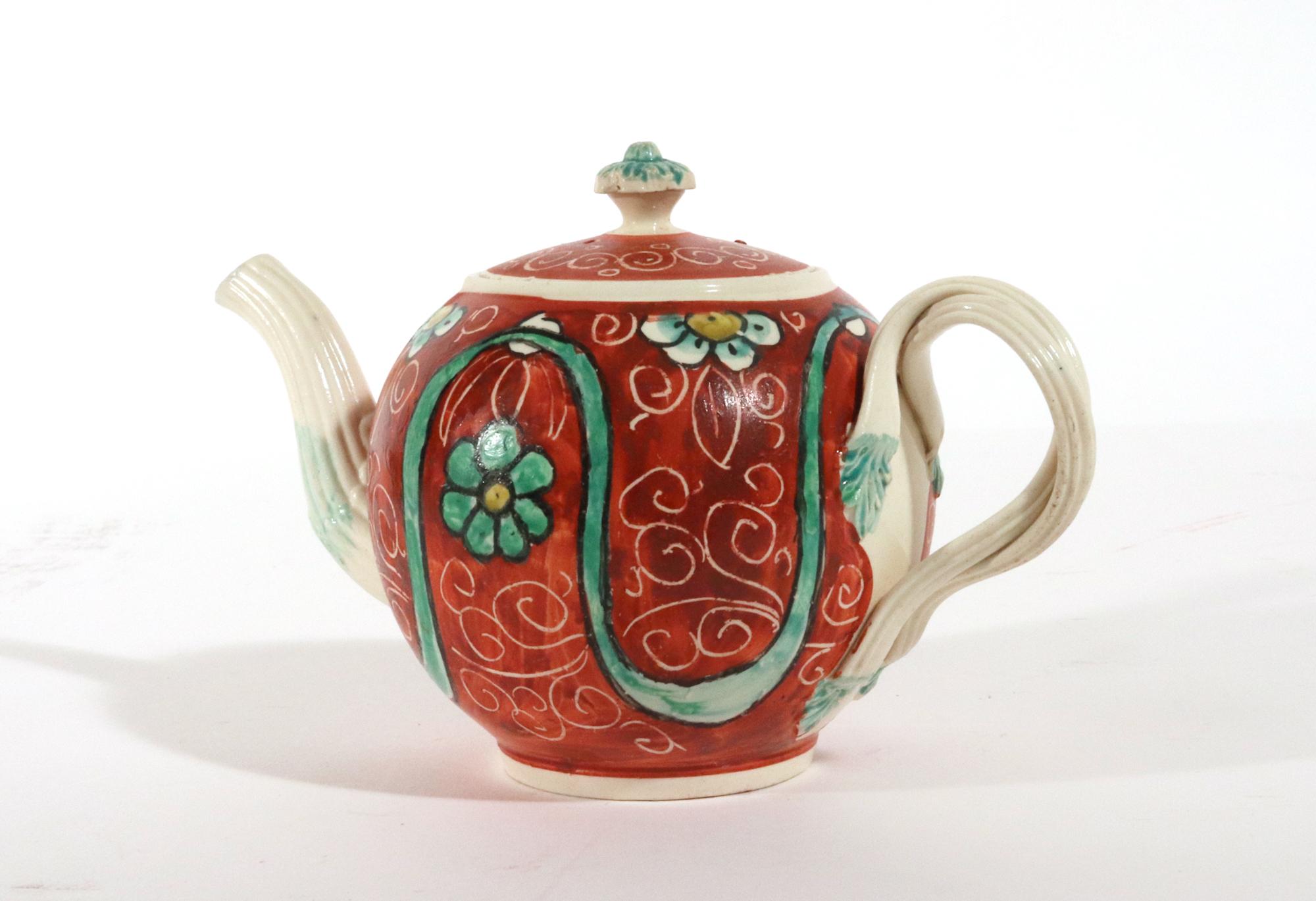 George III English Painted Orange-ground Creamware Teapot and Cover