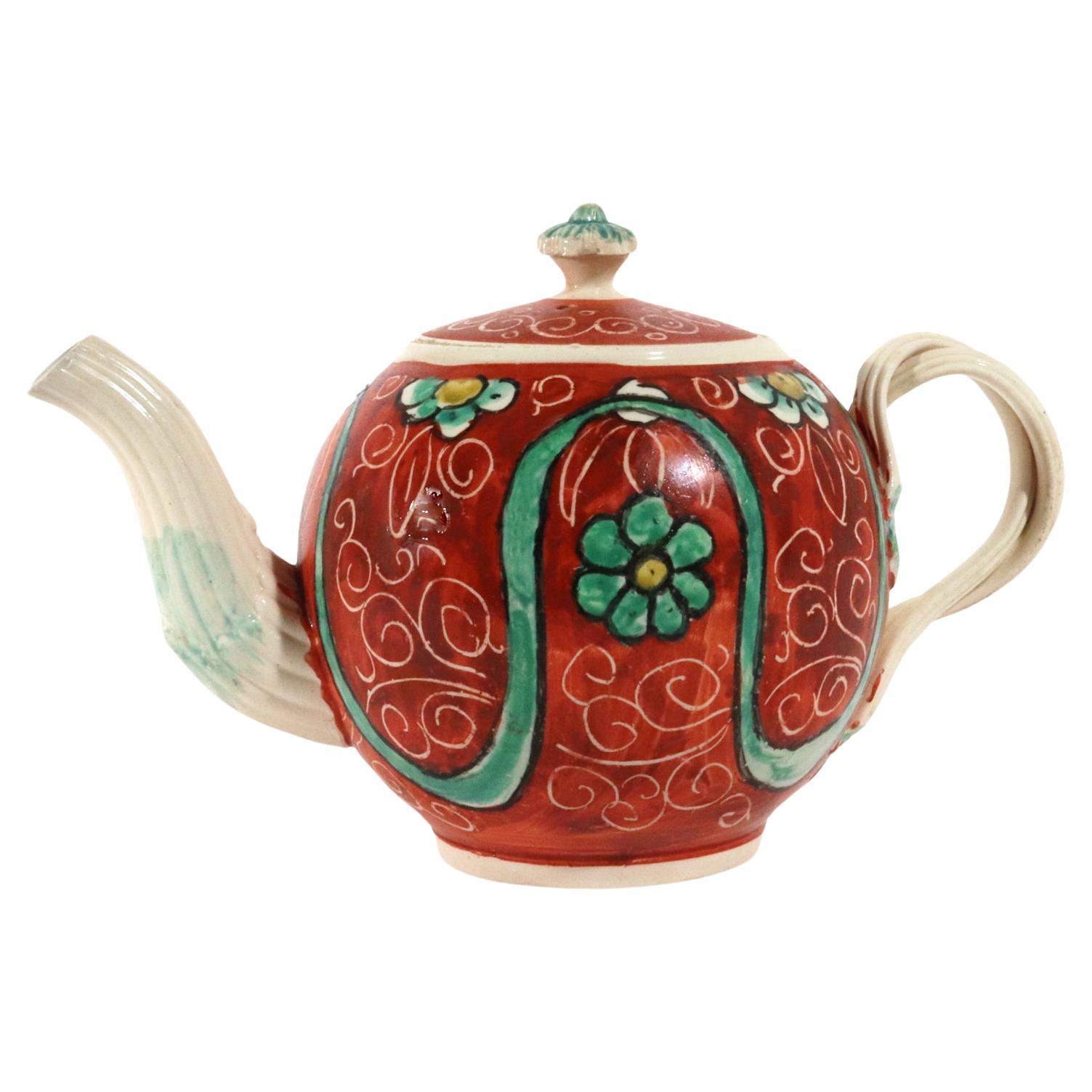 English Painted Orange-ground Creamware Teapot and Cover For Sale