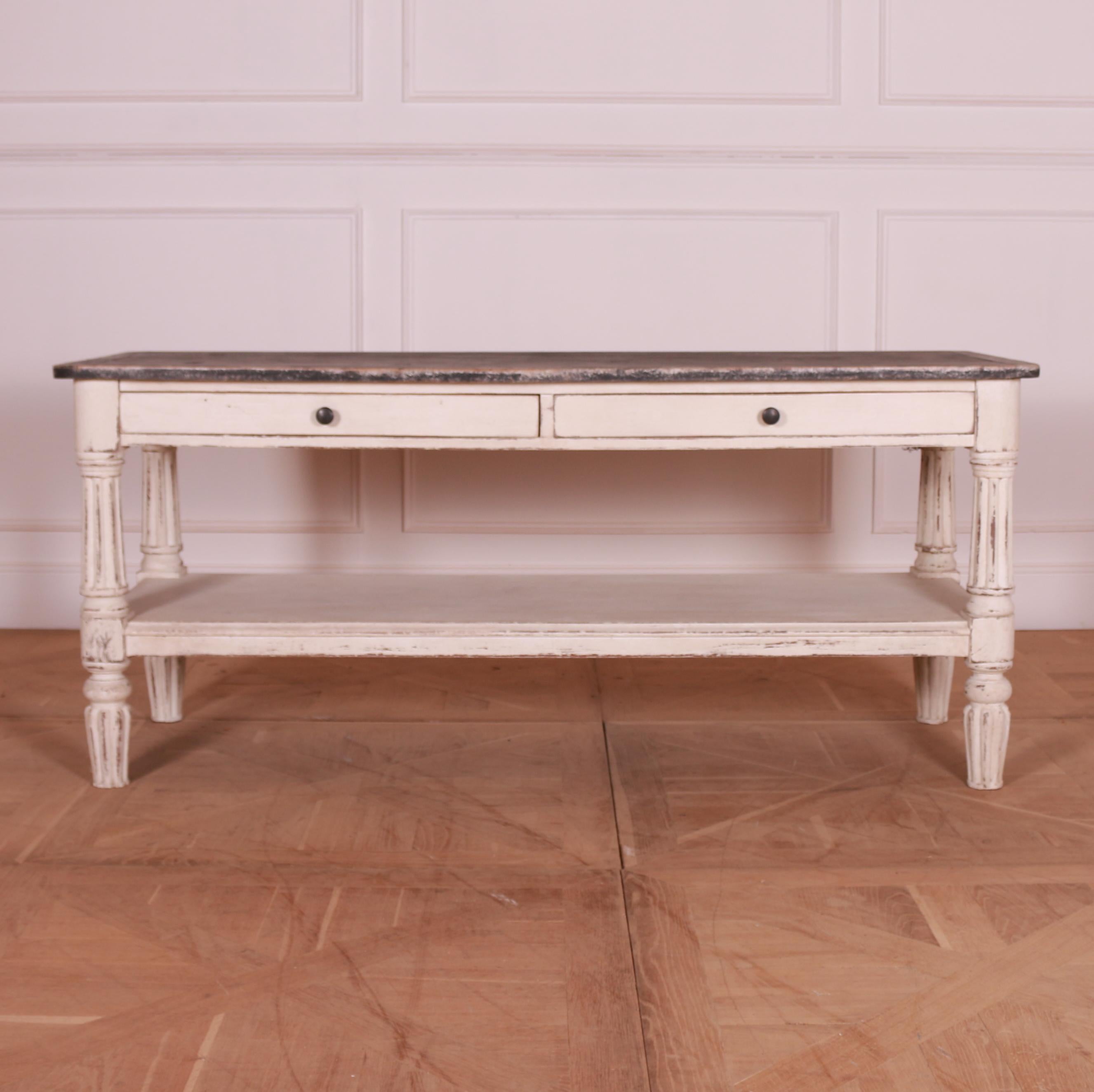 Unusual English painted pine two drawer side table with under-tier and reeded legs. 1860.

Dimensions
66.5 inches (169 cms) Wide
23.5 inches (60 cms) Deep
29 inches (74 cms) High.

   