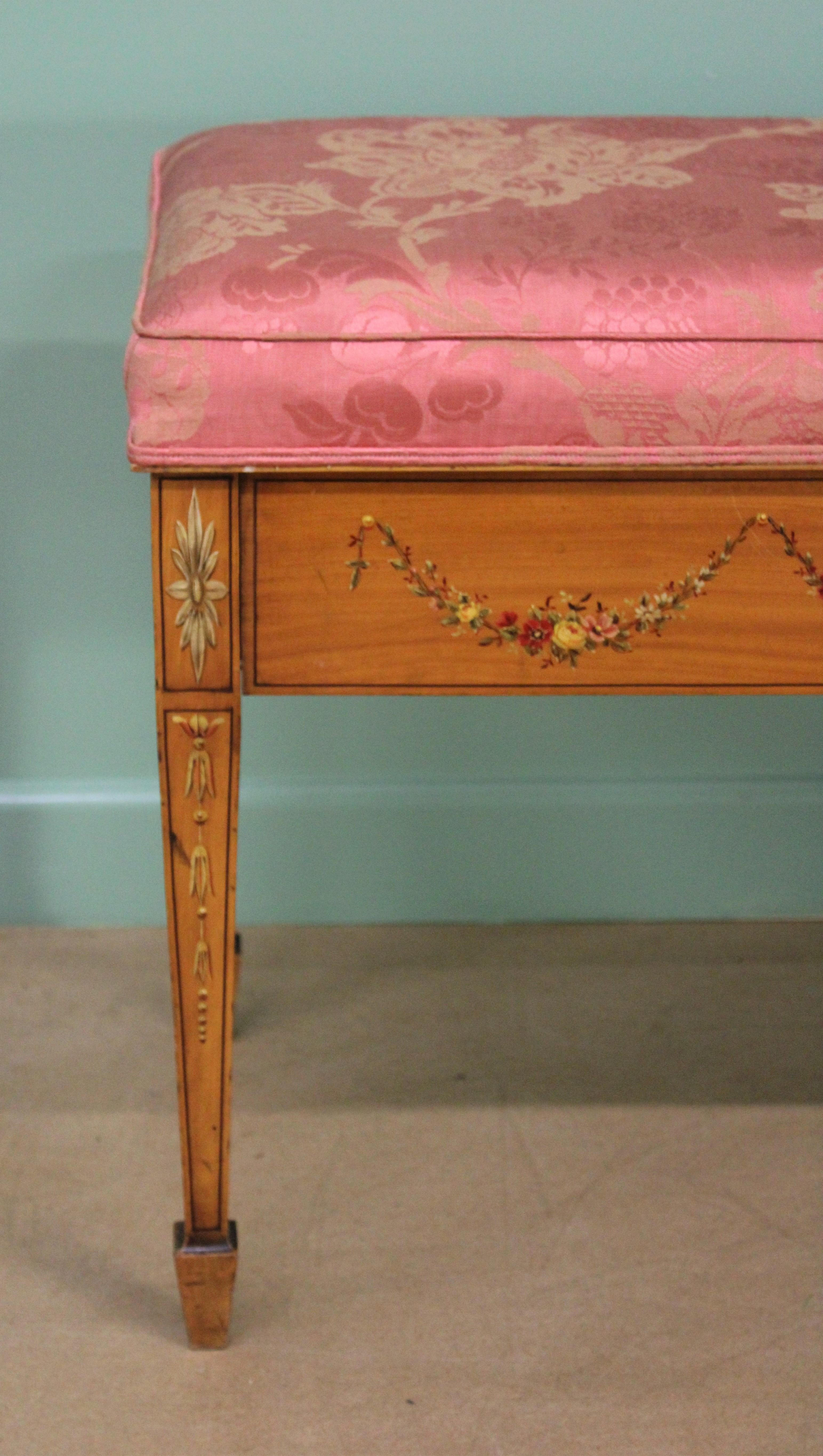 An attractive late Victorian period painted satinwood piano duet stool. Of Fine construction and in very good original condition. Beautifully decorated with hand painted motifs throughout , including harebells and floral garlands. The upholstered