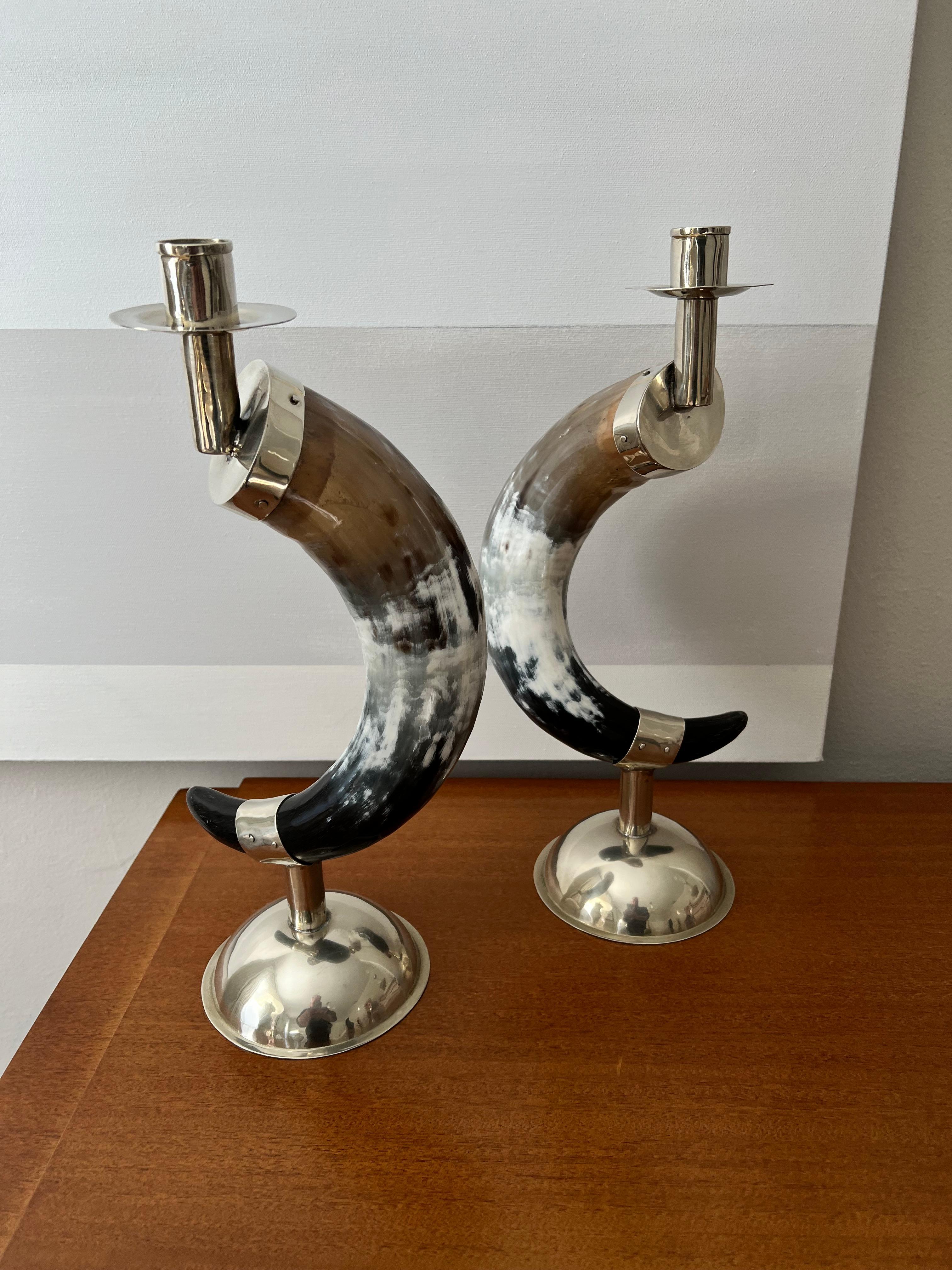 Pair of English horn candlesticks with hand crafted silver plate base and holders. The pair are exquisitely done and are stunning. 

A compliment in many settings and would work well with Modern and clean to maximal homes with traditional or