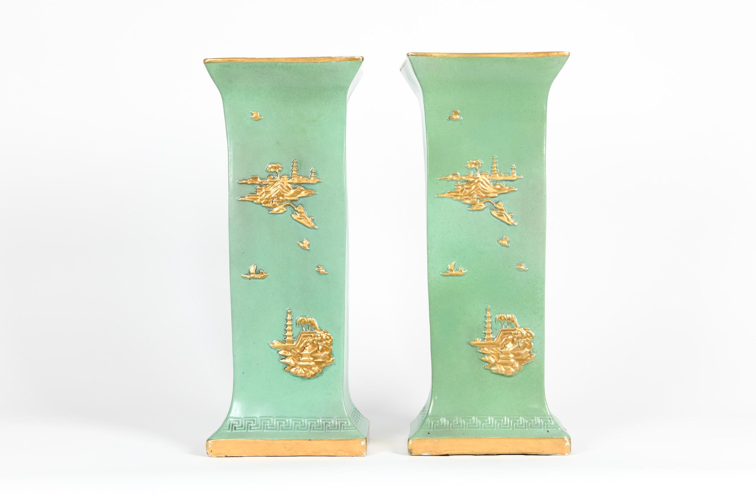English pair glazed and parcel gilt design details porcelain decorative vases/pieces with asiatic details. Each piece is in great vintage condition with minor wear consistent with age/use. Each piece stand about 18.5 inches high X 7. 5 inches X 5 .5