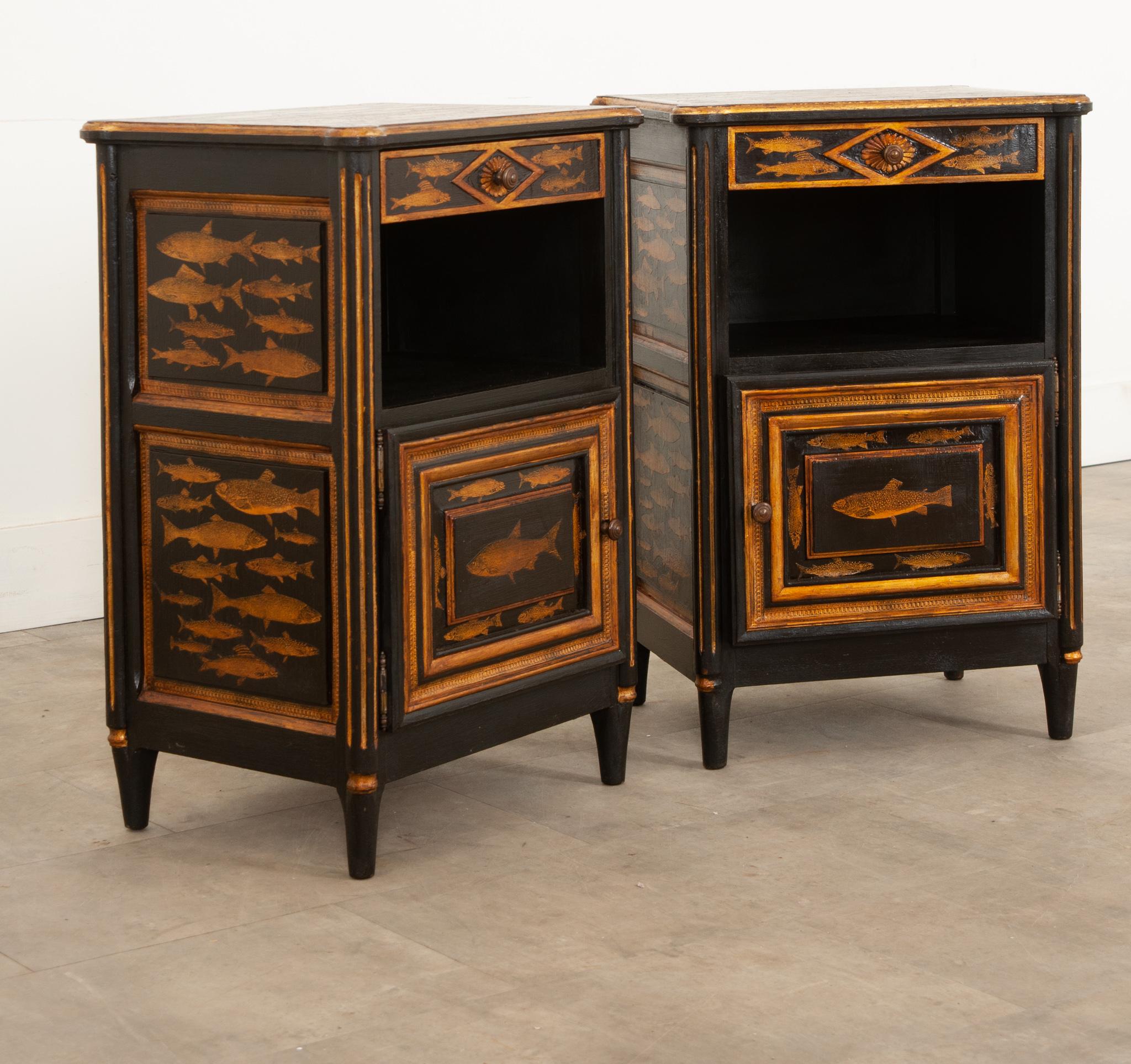 A fanciful set of two antique pine bedside cabinets that date circa 1890 that have been recently painted black with a fish decoupage design. These cabinets will add a whimsical flair to any room in your house, especially a bedroom as there is plenty