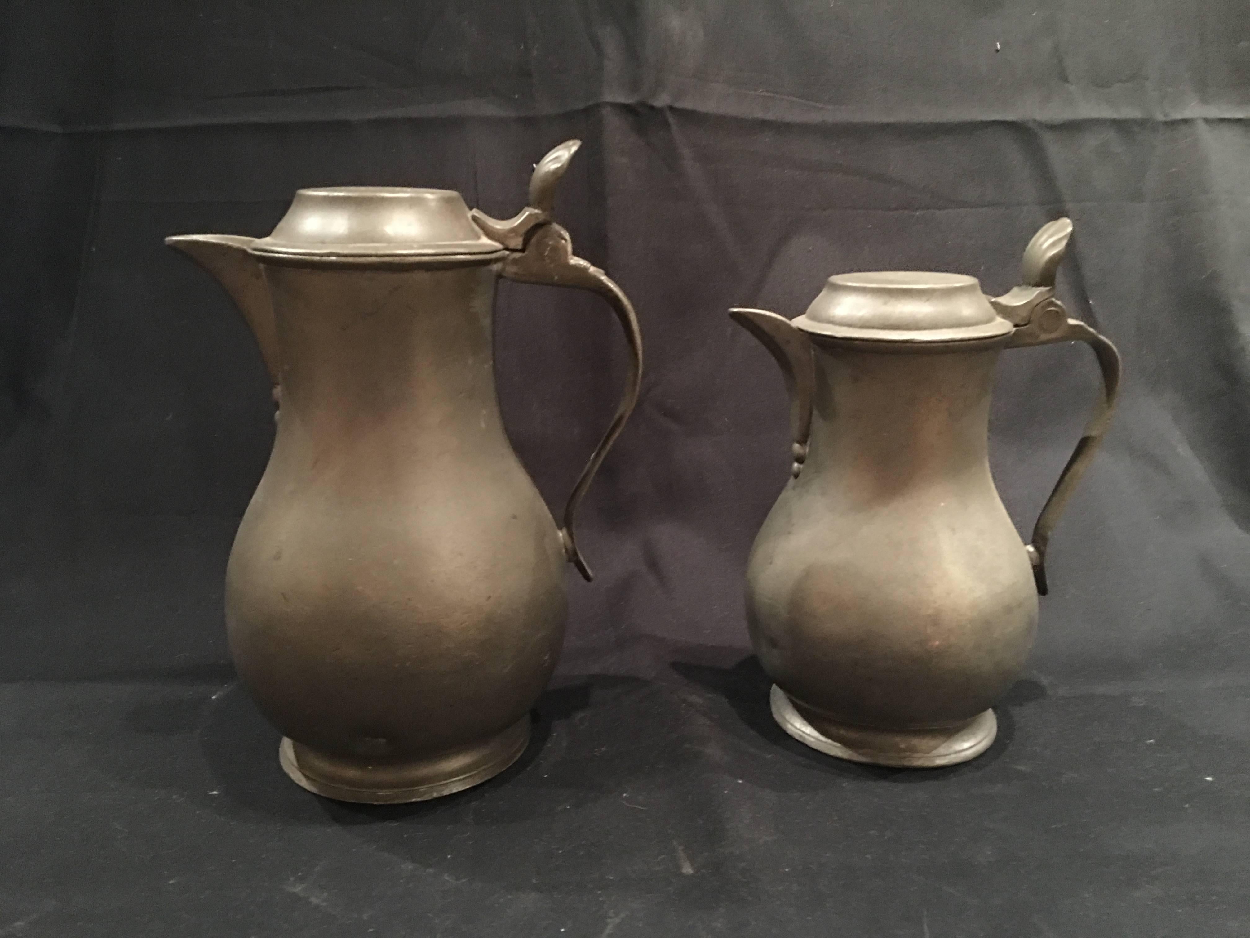 English pair of lidded Pewter jugs or tankards with handles, 19th century.