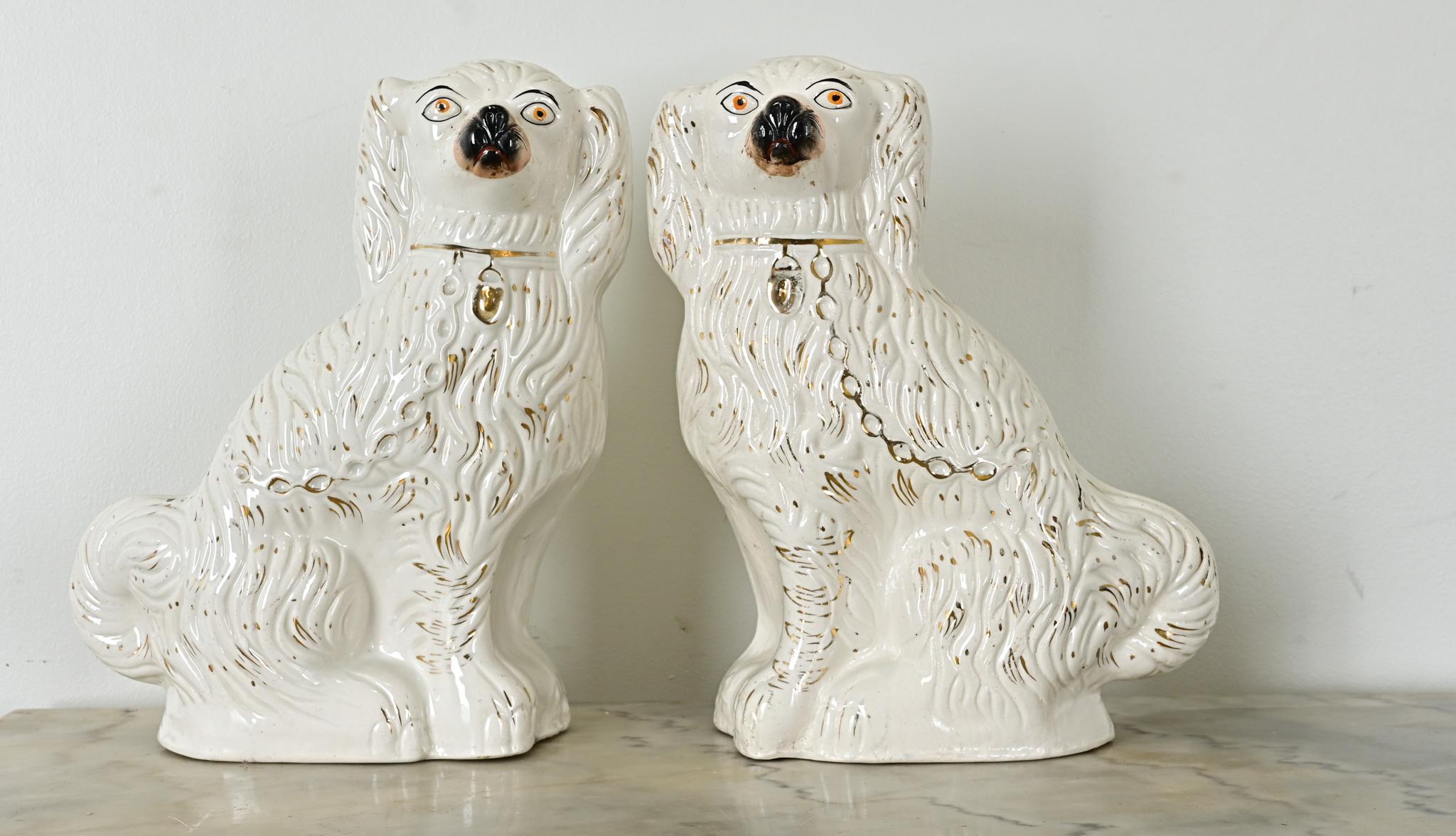 Staffordshire Dogs are named so for the area in England where they originated, representations of the King Charles Spaniel breed favored by the monarchy. In this charming pair, their unusual scale is matched in quality with delicately applied gold