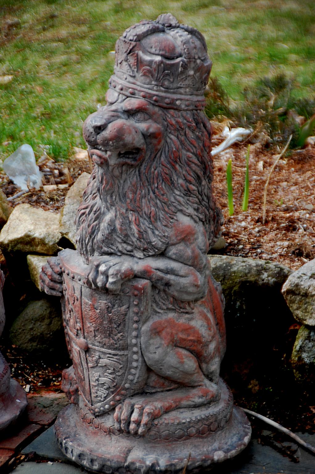 English pair of terracotta crowned rampant lions holding a shield emblazoned with a coat of arms. These beautifully detailed statues are quite heavy for their size and would make a substantial addition to a garden, entrance, home or office, mid-20th