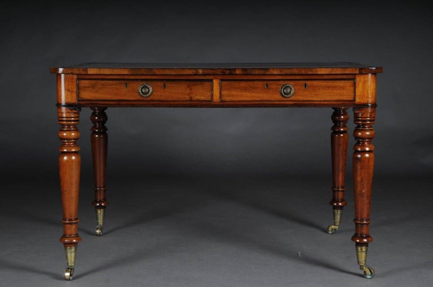 Solid mahogany partially veneered. Baluster-shaped table legs. Two-drawer frame box profiled on both sides, slightly protruding table top. Writing surface decorated with unusual gold embossing. Decorative brass fittings. Victoria style

(L-133)